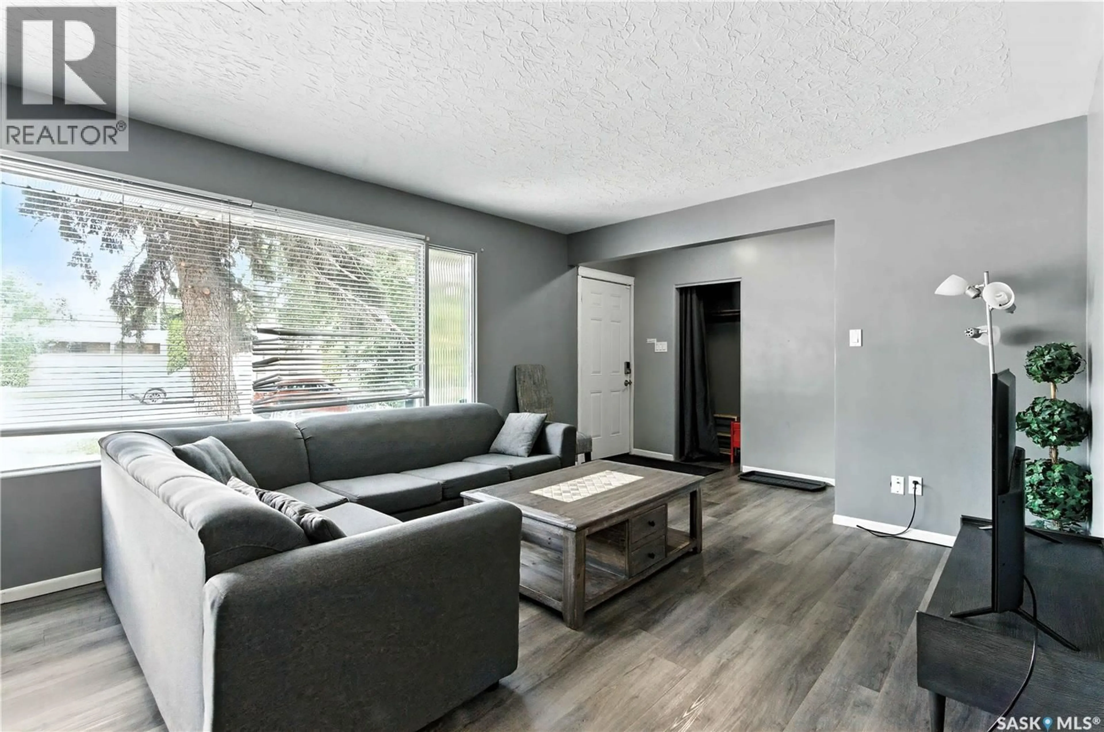 Living room with furniture, wood/laminate floor for 1426 10TH STREET, Saskatoon Saskatchewan S7H0J5