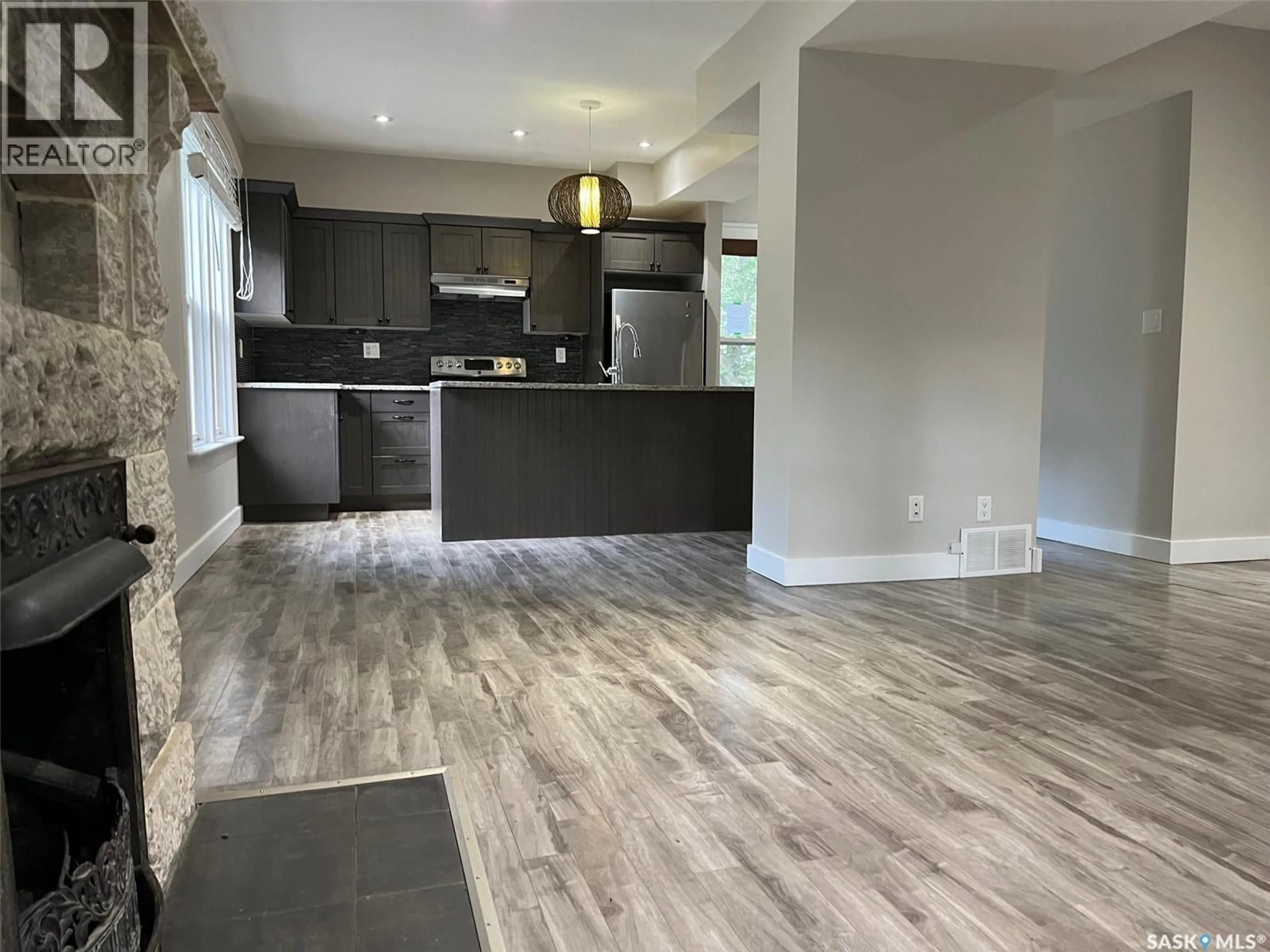 Open concept kitchen, wood/laminate floor for 2059 ELPHINSTONE STREET, Regina Saskatchewan S4T3N5