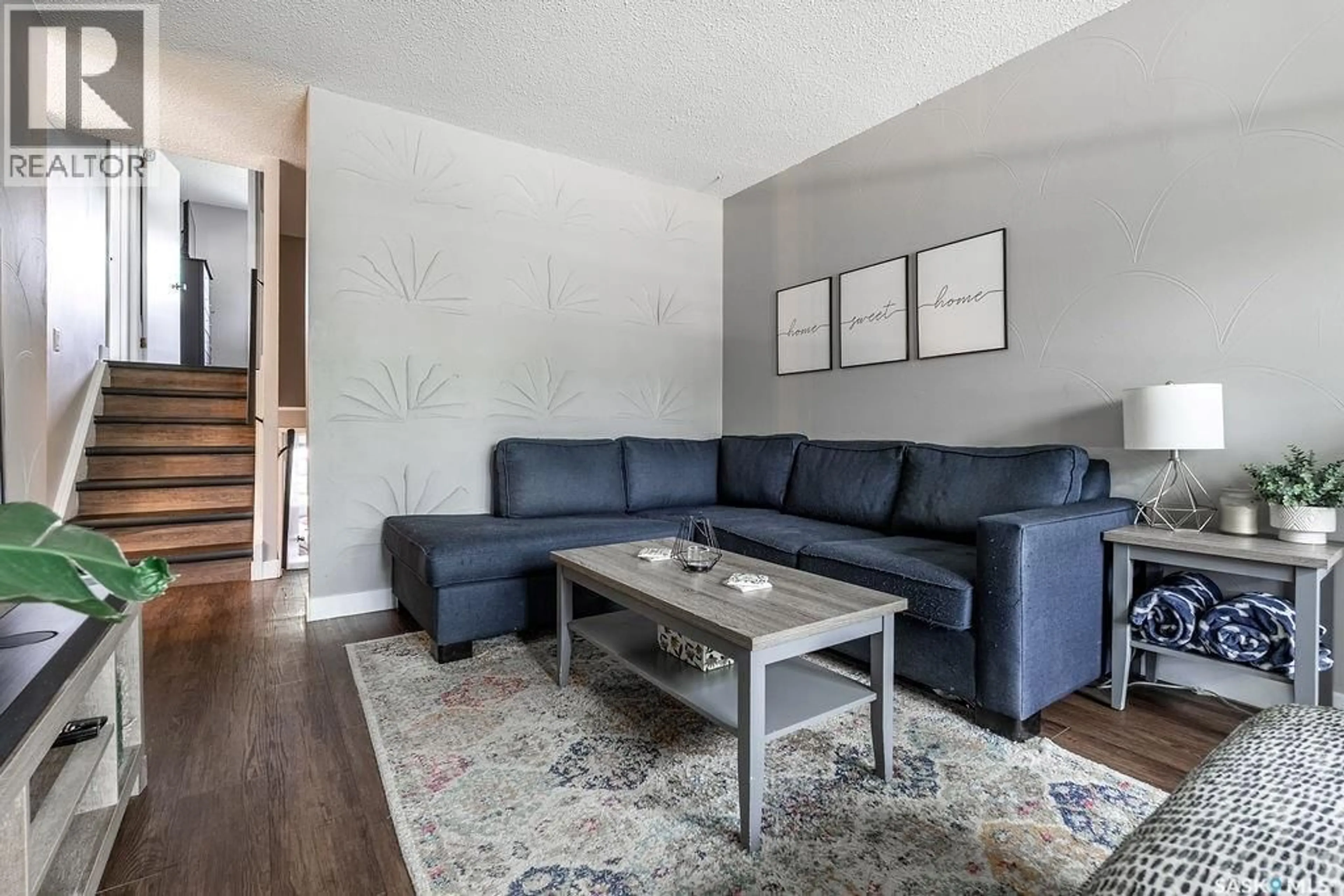 Living room with furniture, wood/laminate floor for 433 EAST PLACE, Saskatoon Saskatchewan S7J2Y7