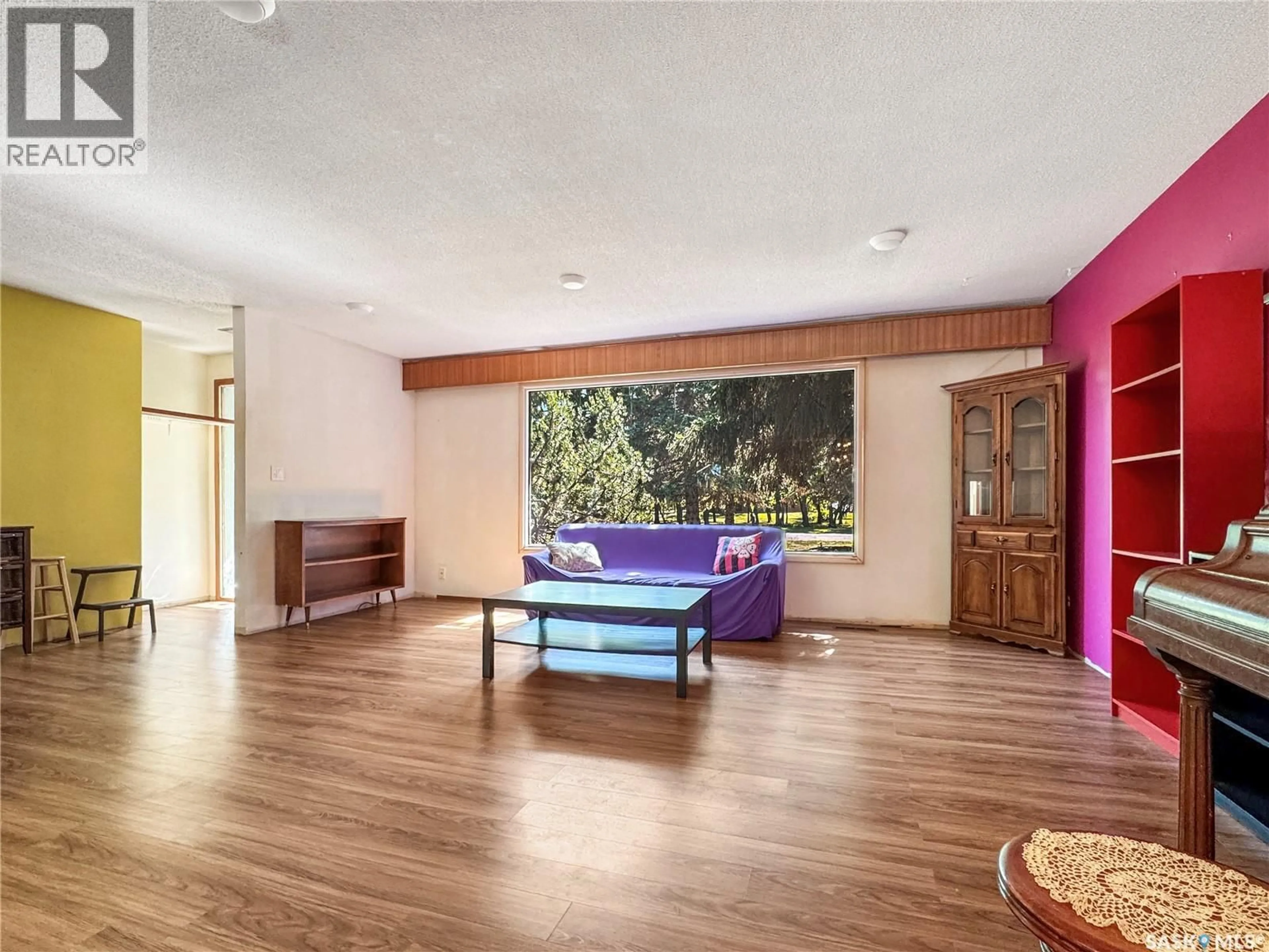 Living room with furniture, wood/laminate floor for 111 DION AVENUE, Cut Knife Saskatchewan S0M0N0