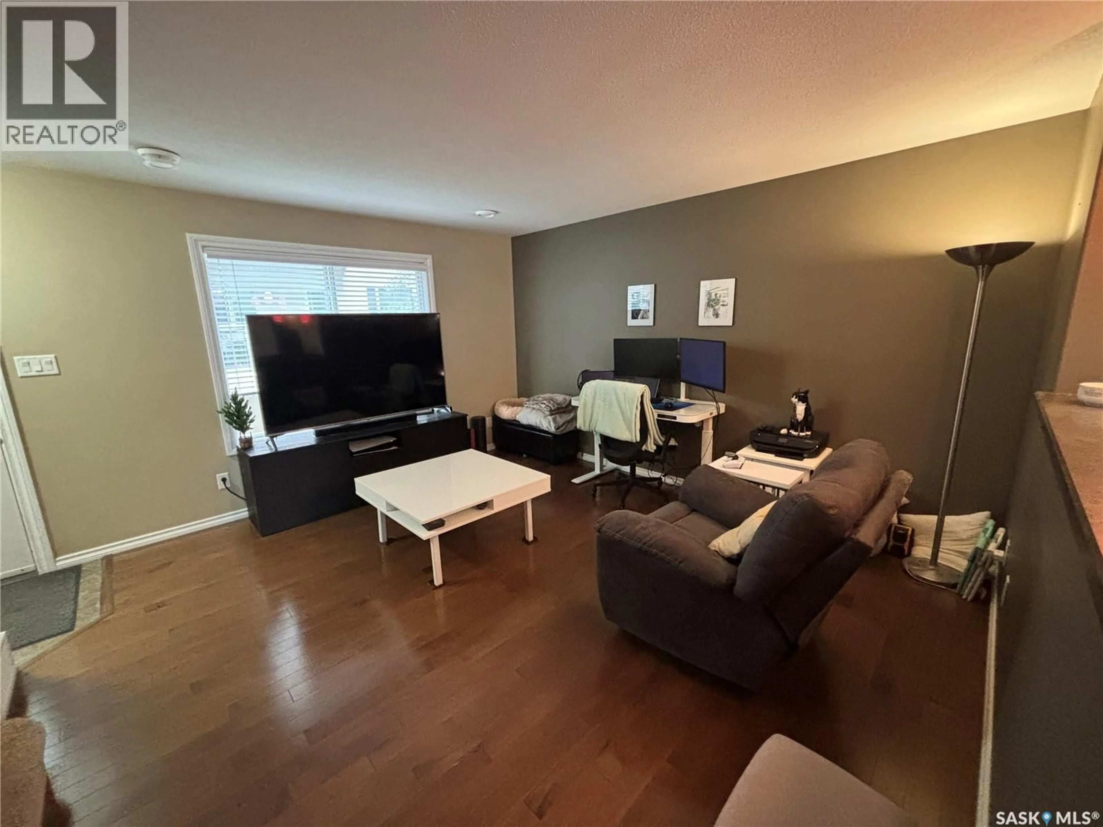 Living room with furniture, wood/laminate floor for 3 - 3225 WOODHAMS DRIVE, Regina Saskatchewan S4V3A2