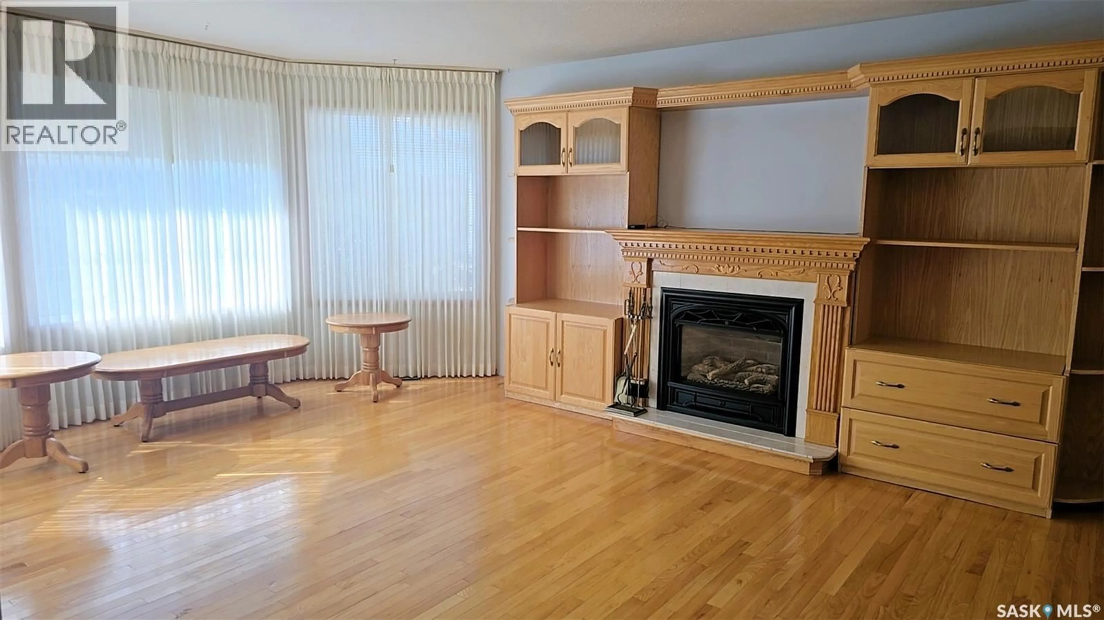 Living room with furniture, wood/laminate floor for 210 3RD STREET, Vanscoy Saskatchewan S0L3J0