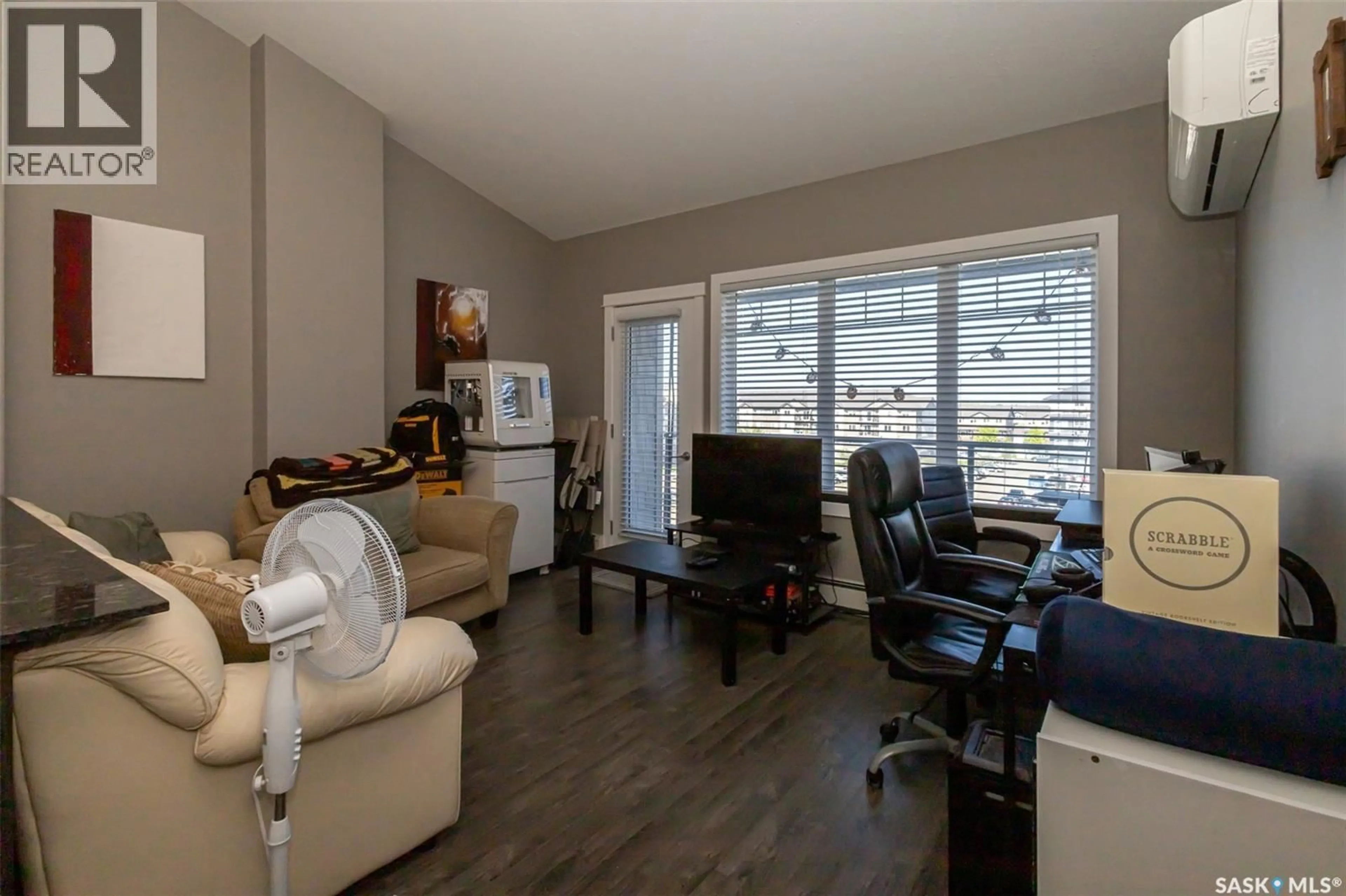 Living room with furniture, wood/laminate floor for 714 - 408 HART ROAD, Saskatoon Saskatchewan S7M1L2
