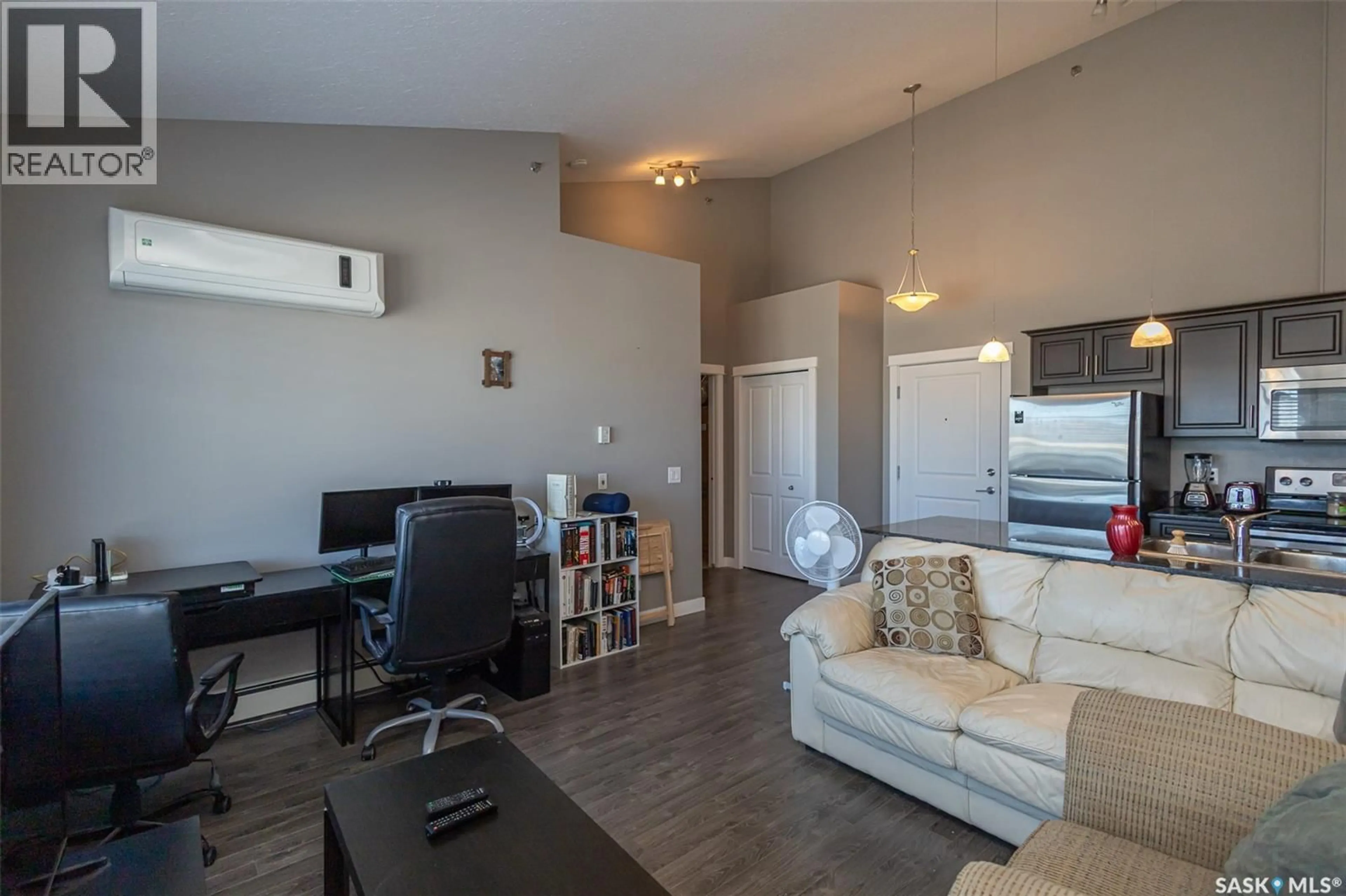Living room with furniture, wood/laminate floor for 714 - 408 HART ROAD, Saskatoon Saskatchewan S7M1L2