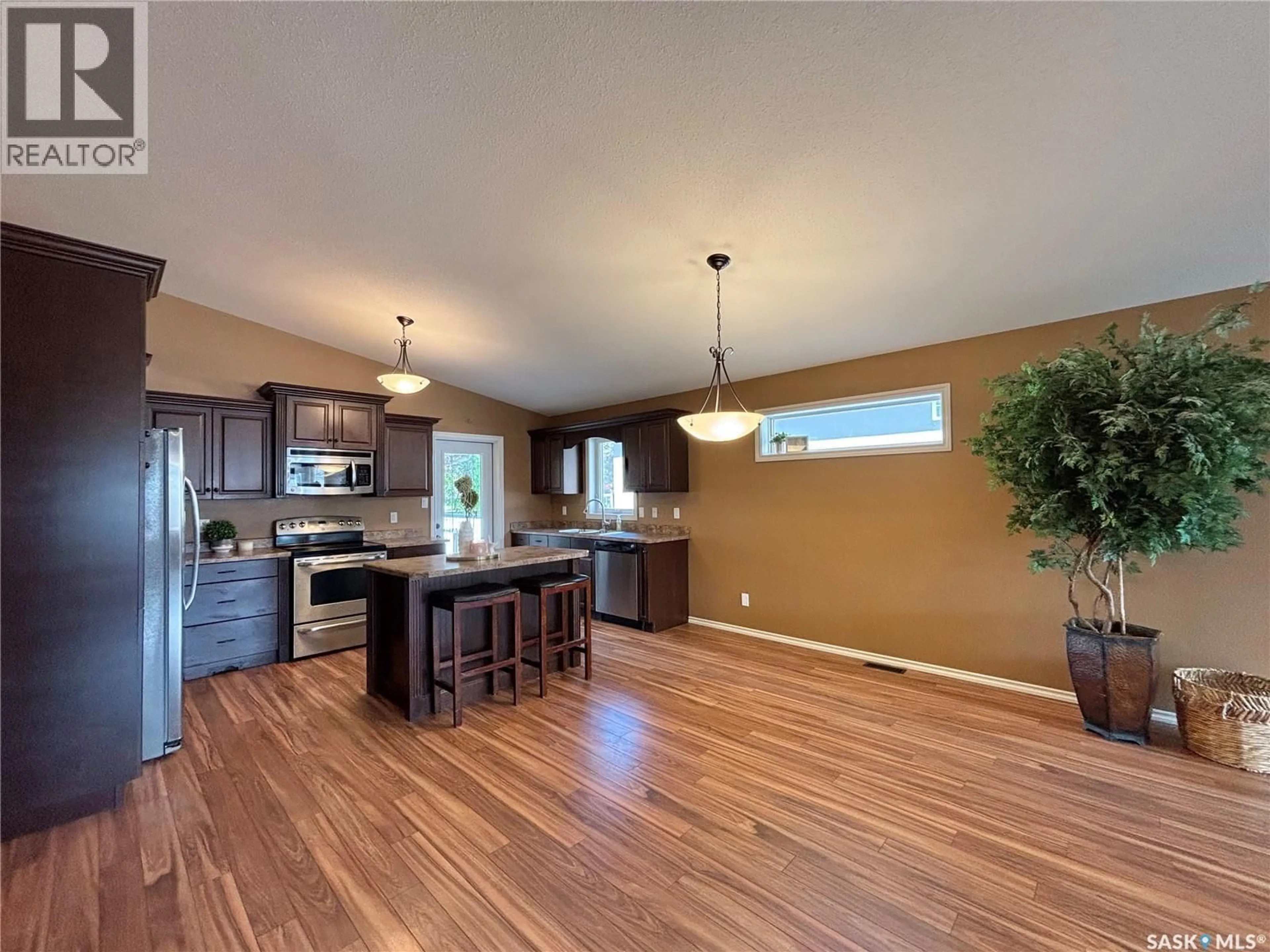 Open concept kitchen, wood/laminate floor for 67 GOOD SPIRIT CRESCENT, Yorkton Saskatchewan S3N0X1