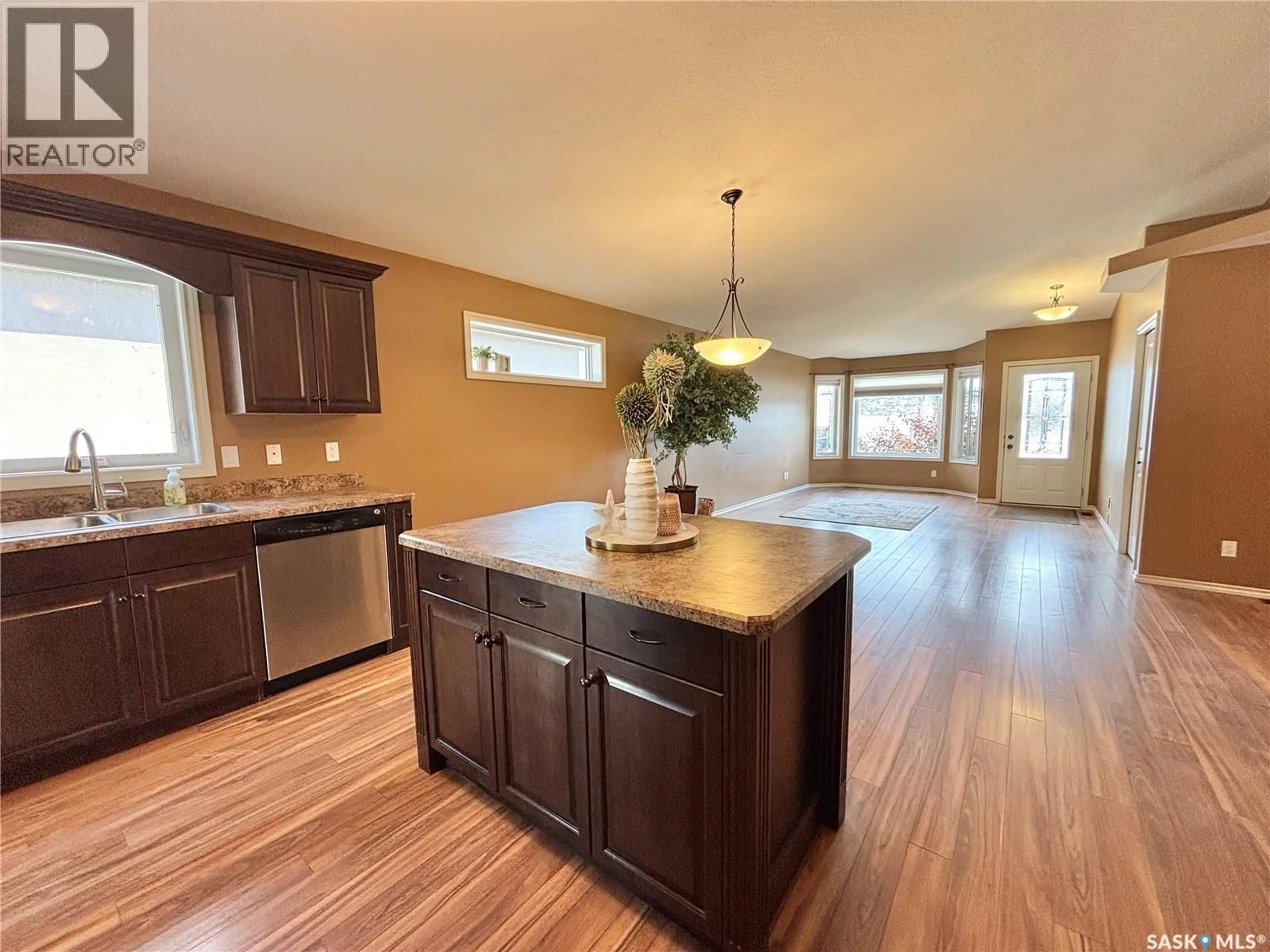 Open concept kitchen, wood/laminate floor for 67 GOOD SPIRIT CRESCENT, Yorkton Saskatchewan S3N0X1