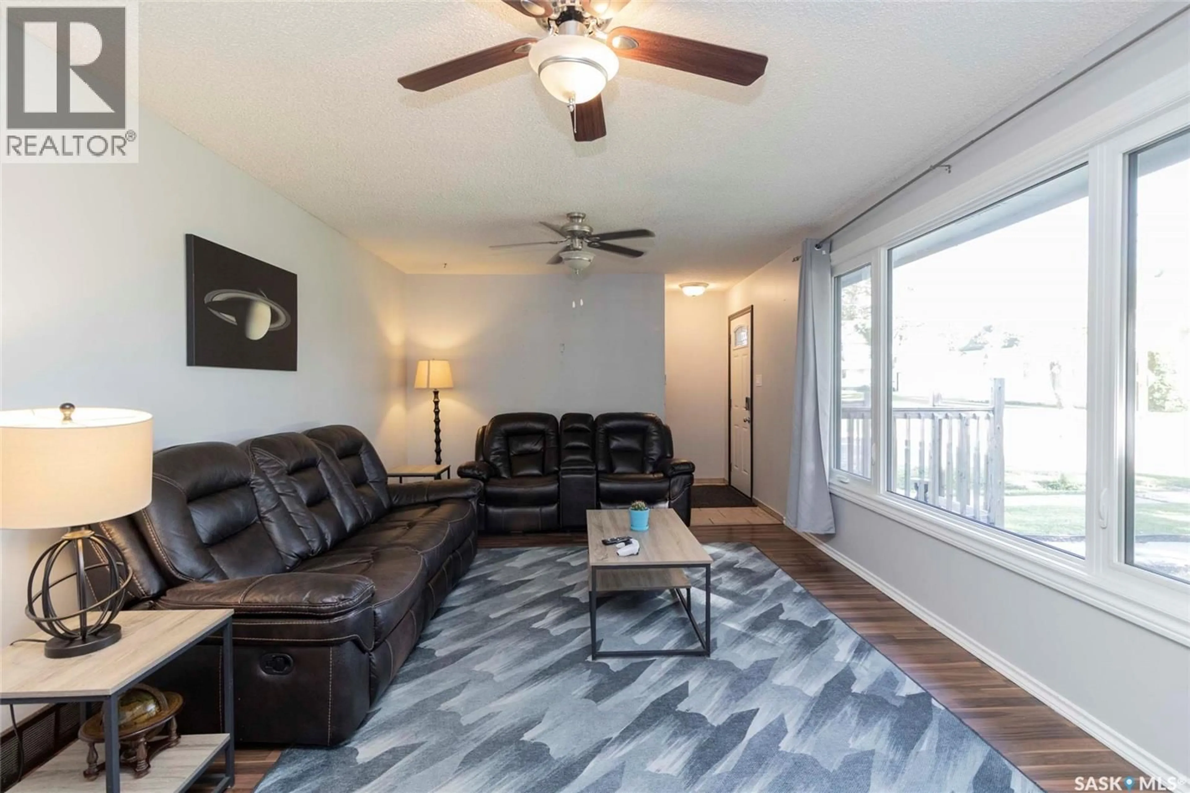 Living room with furniture, wood/laminate floor for 217 2ND STREET, Langham Saskatchewan S0K2L0