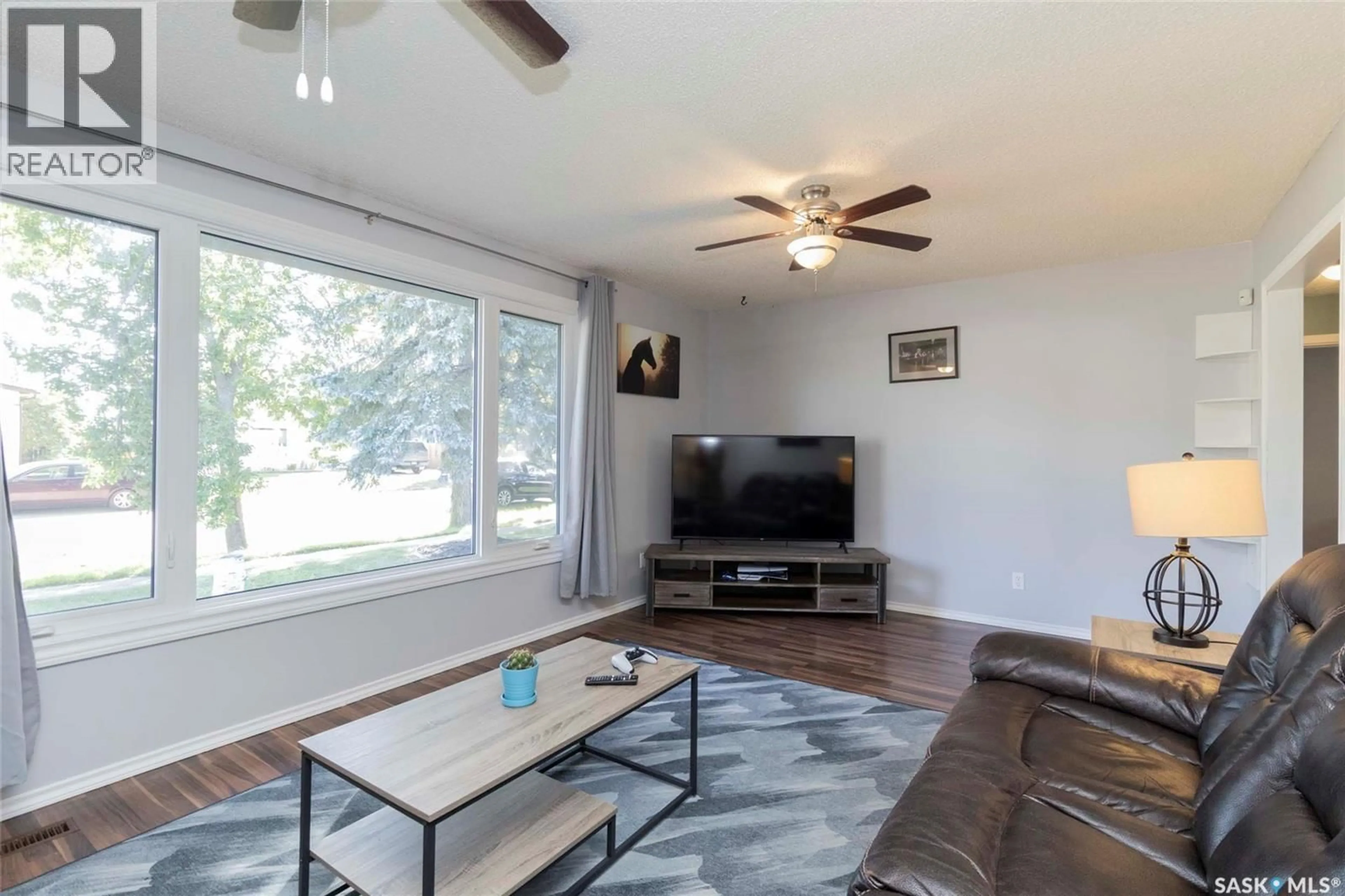 Living room with furniture, wood/laminate floor for 217 2ND STREET, Langham Saskatchewan S0K2L0