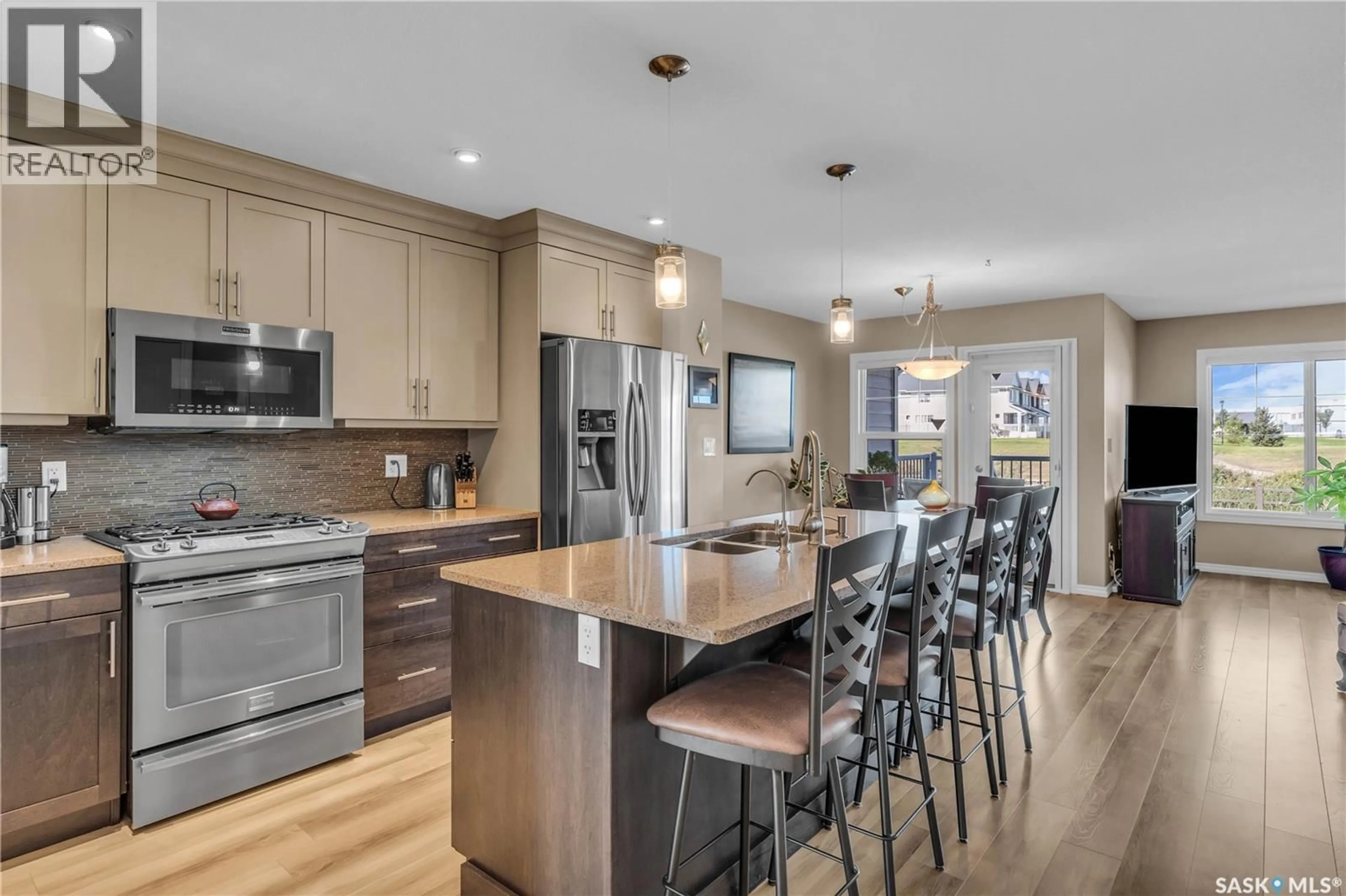 Open concept kitchen, wood/laminate floor for 4532 HARBOUR VILLAGE WAY, Regina Saskatchewan S4W0C1