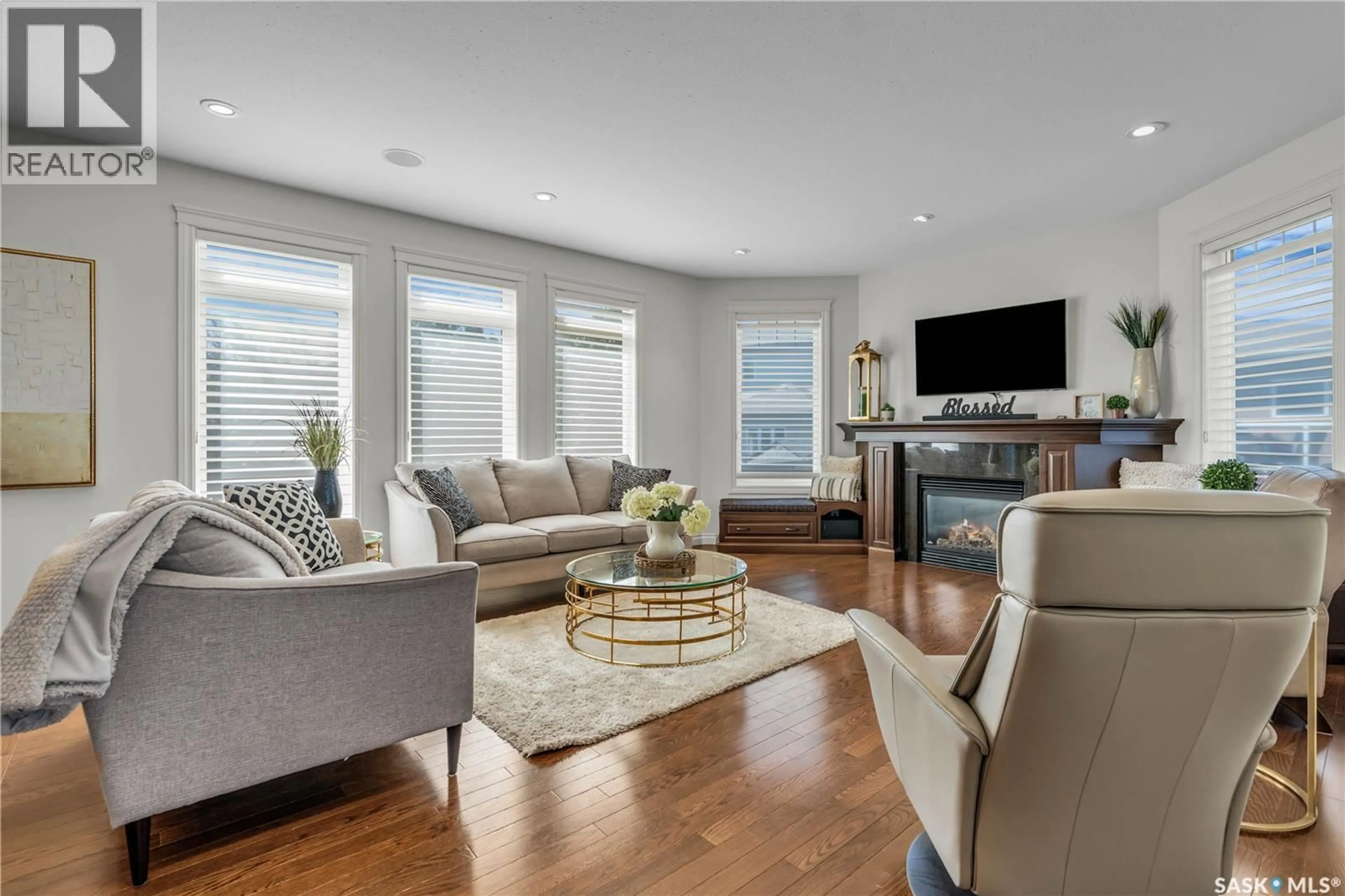 Living room with furniture, wood/laminate floor for 130 SKUCE PLACE, Saskatoon Saskatchewan S7M0G8