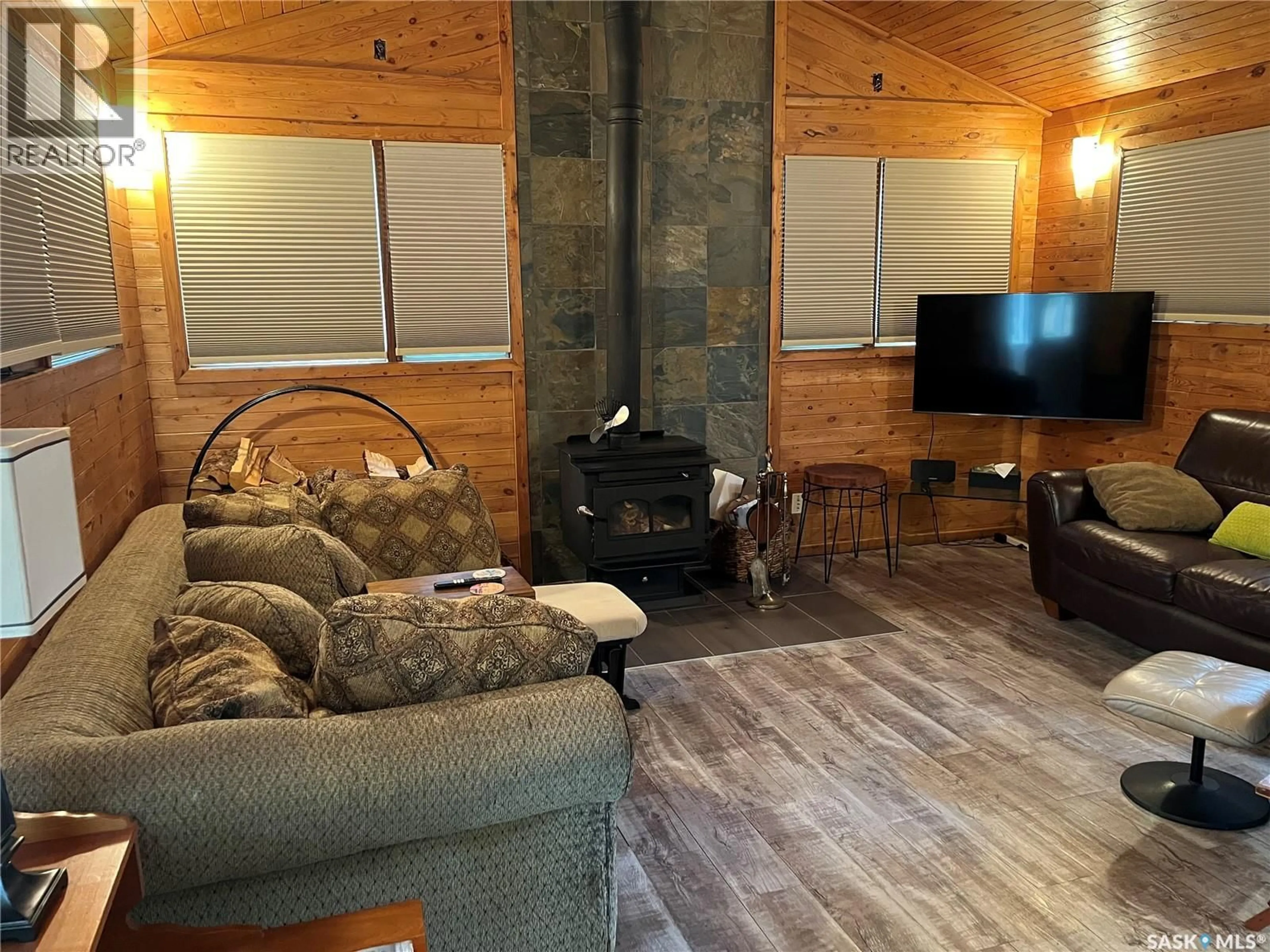 Living room with furniture, wood/laminate floor for 324 KENDERDINE CRESCENT, Lakeland Rm No. 521 Saskatchewan S0J0N0