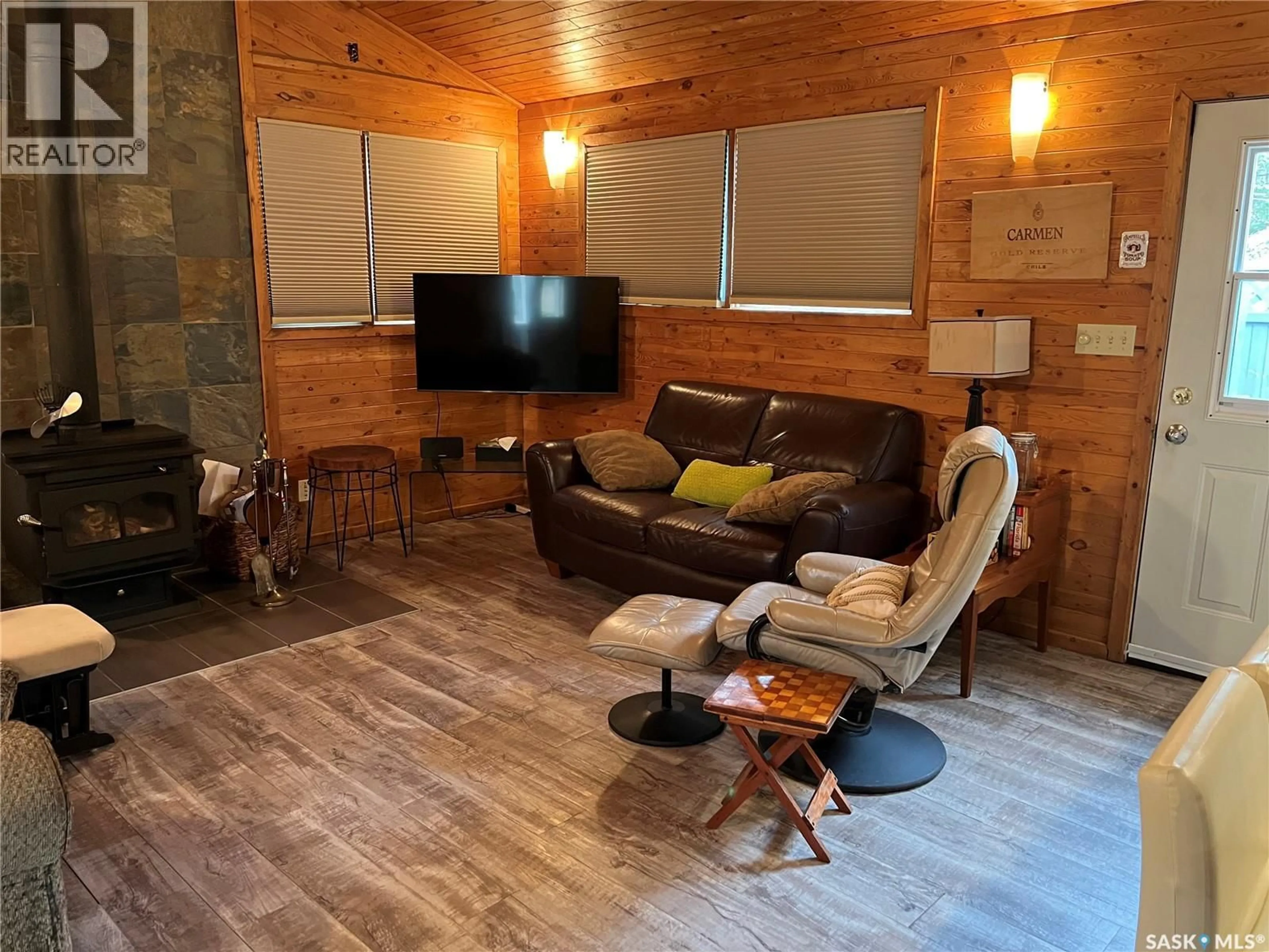 Living room with furniture, wood/laminate floor for 324 KENDERDINE CRESCENT, Lakeland Rm No. 521 Saskatchewan S0J0N0