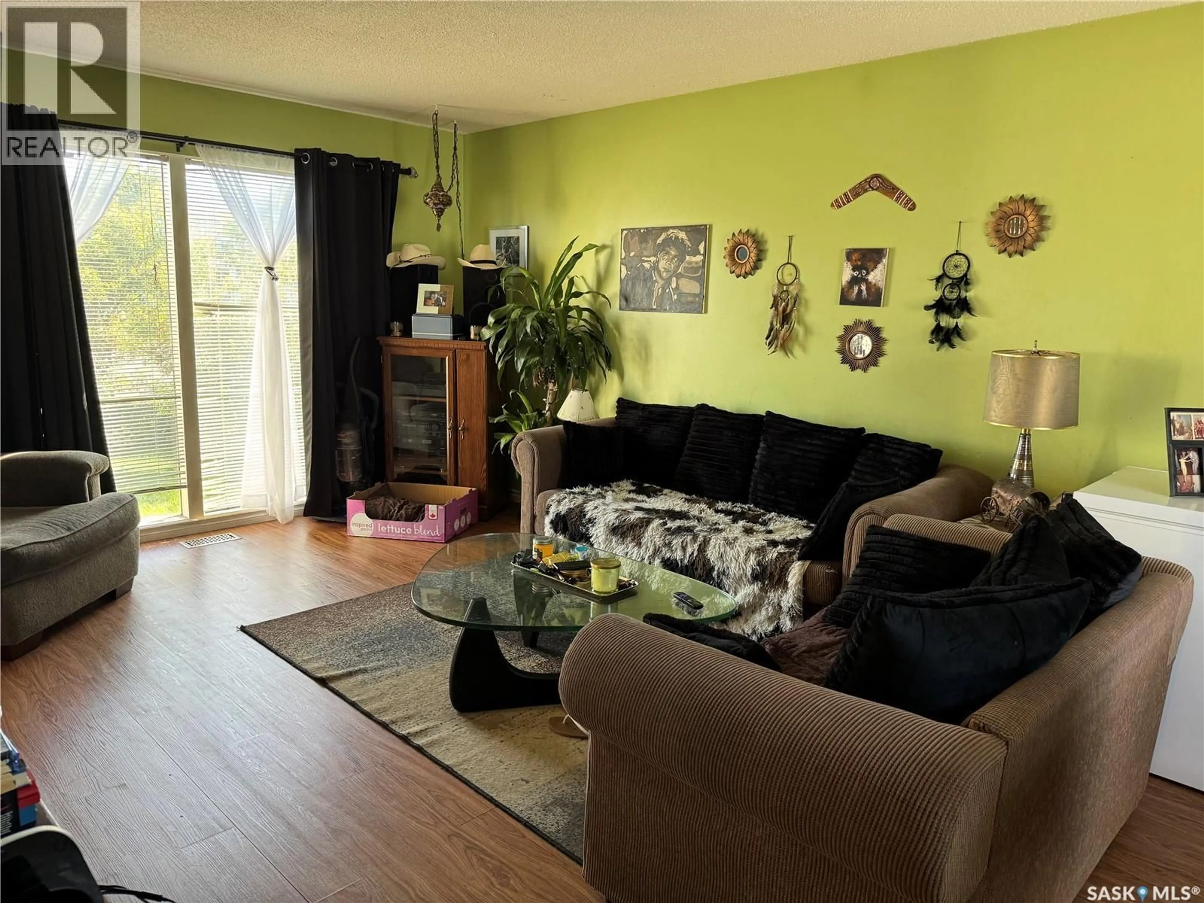 Living room with furniture, wood/laminate floor for 9A & 9B MAPLE PLACE, Lanigan Saskatchewan S0K2M0