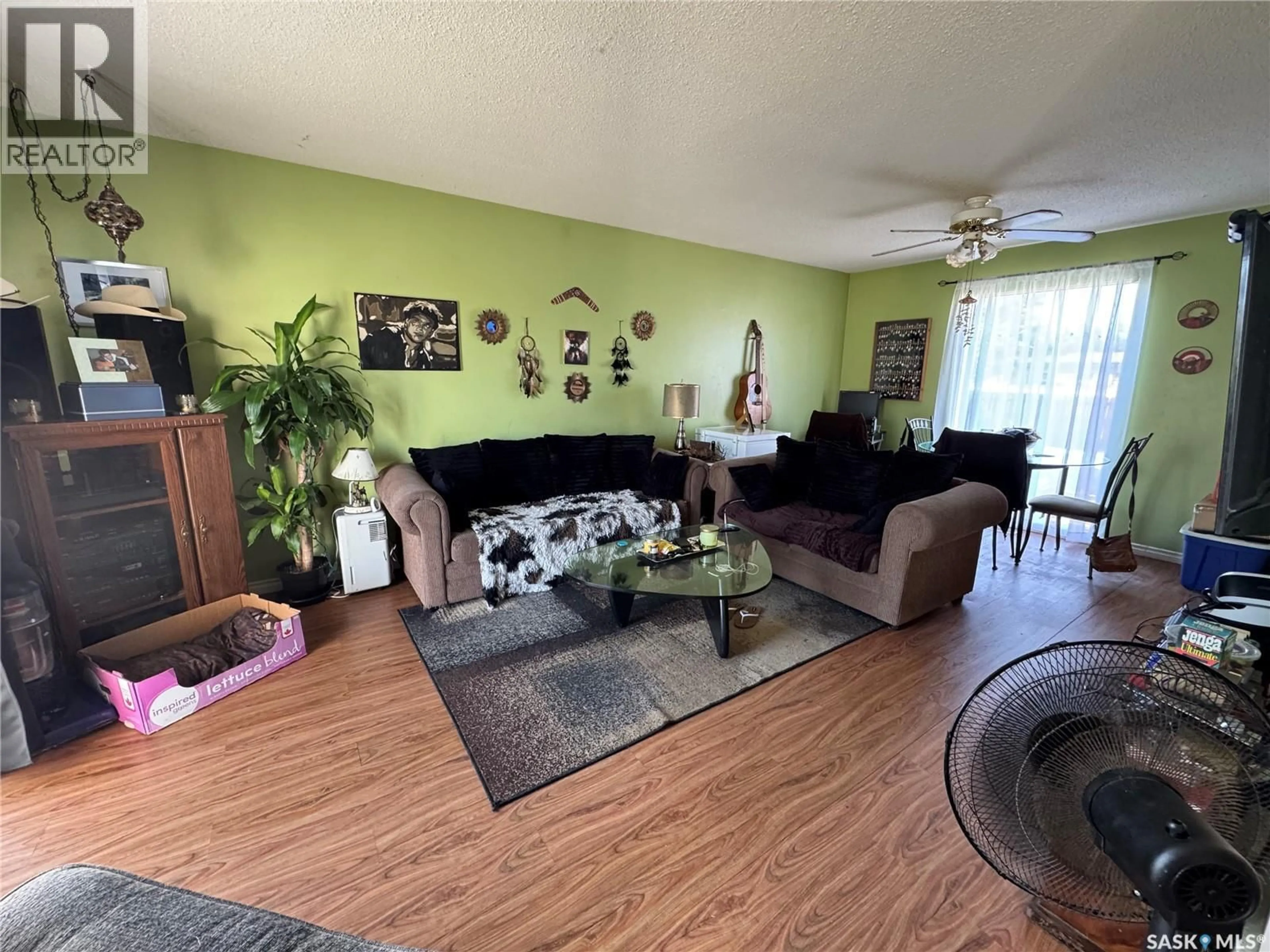 Living room with furniture, wood/laminate floor for 9A & 9B MAPLE PLACE, Lanigan Saskatchewan S0K2M0