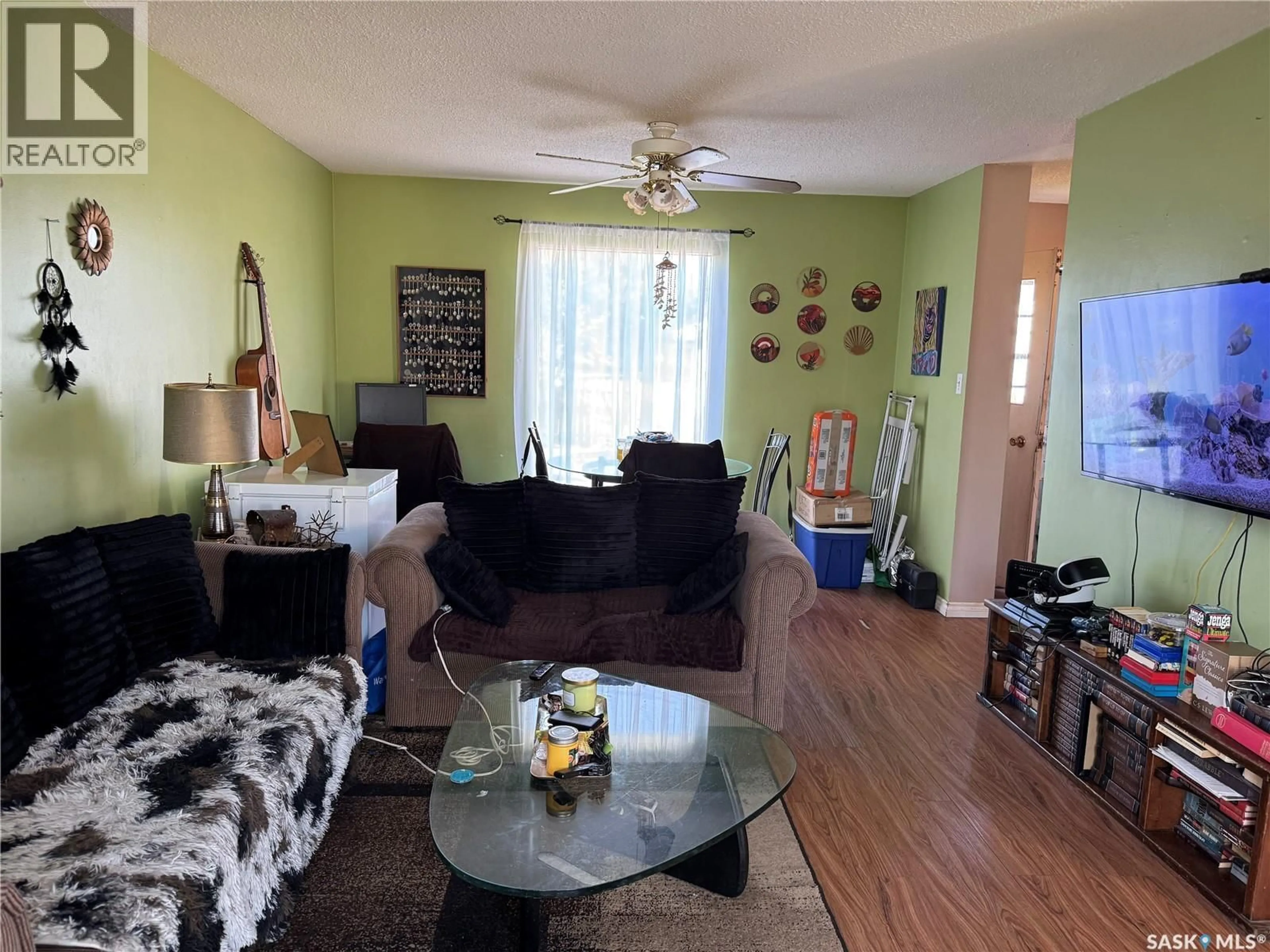 Living room with furniture, wood/laminate floor for 9A & 9B MAPLE PLACE, Lanigan Saskatchewan S0K2M0
