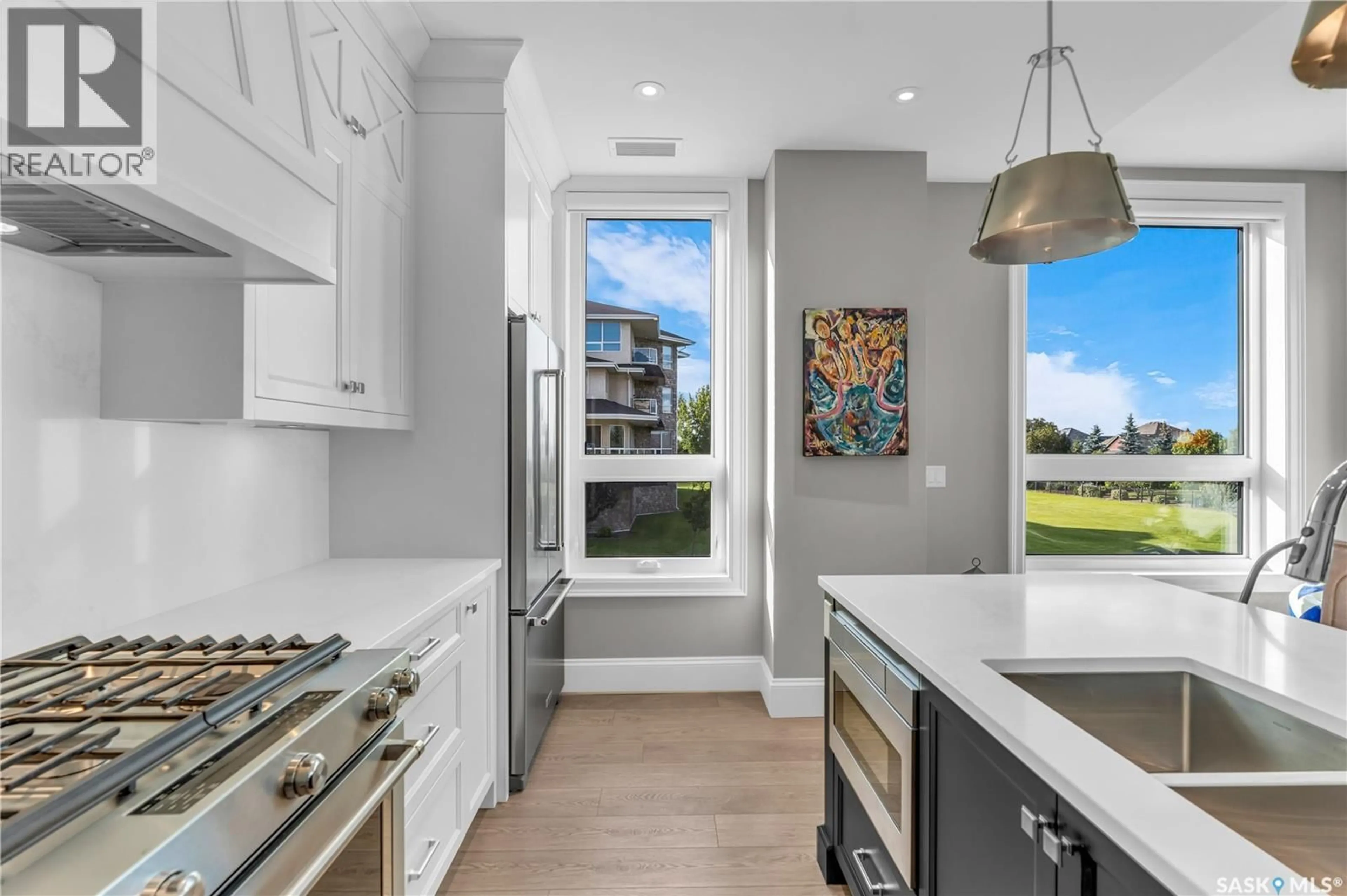 Open concept kitchen, ceramic/tile floor for 101 408 CARTWRIGHT STREET, Saskatoon Saskatchewan S7T0X1