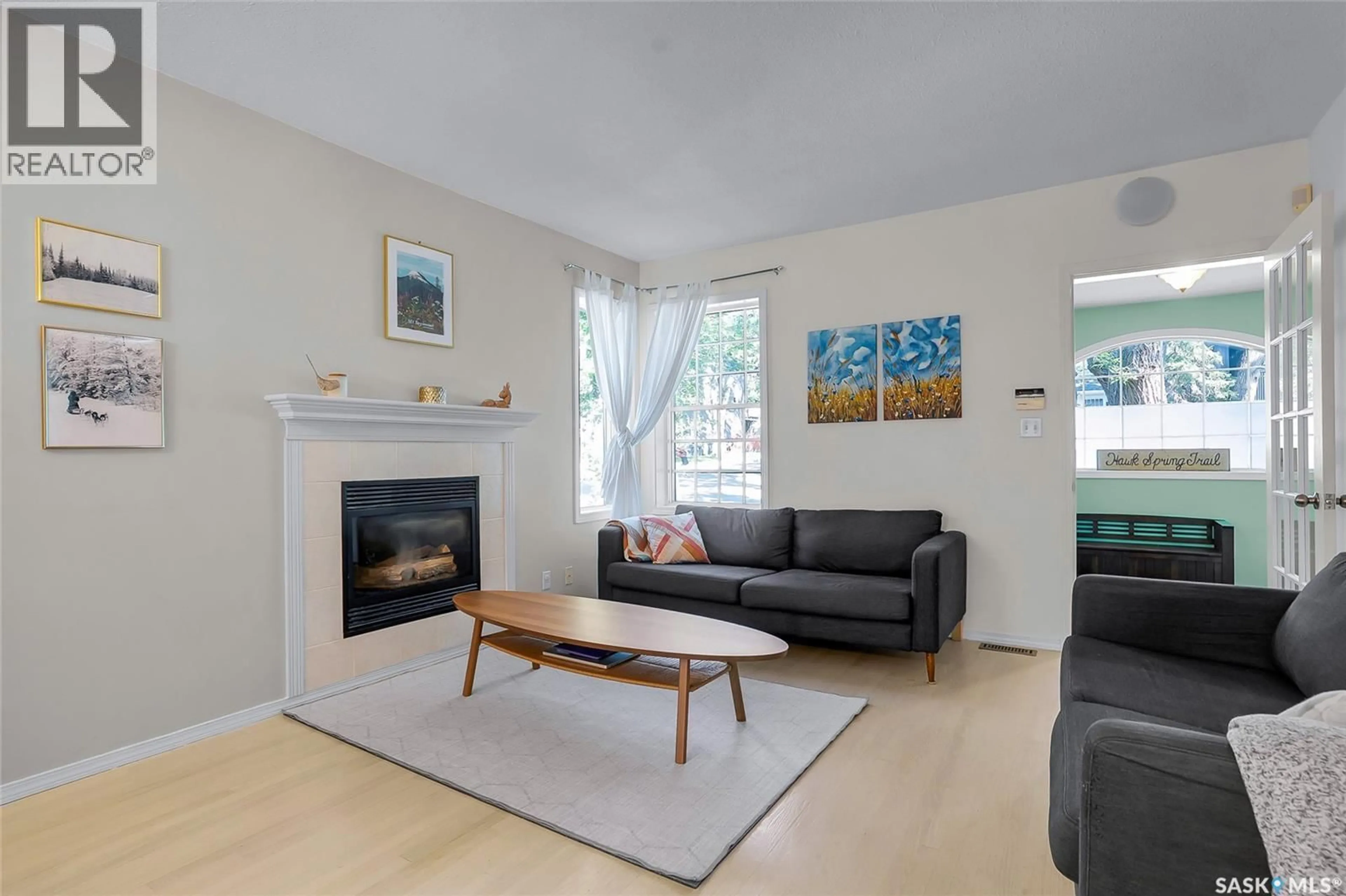 Living room with furniture, wood/laminate floor for 119 28TH STREET, Saskatoon Saskatchewan S7L0K1