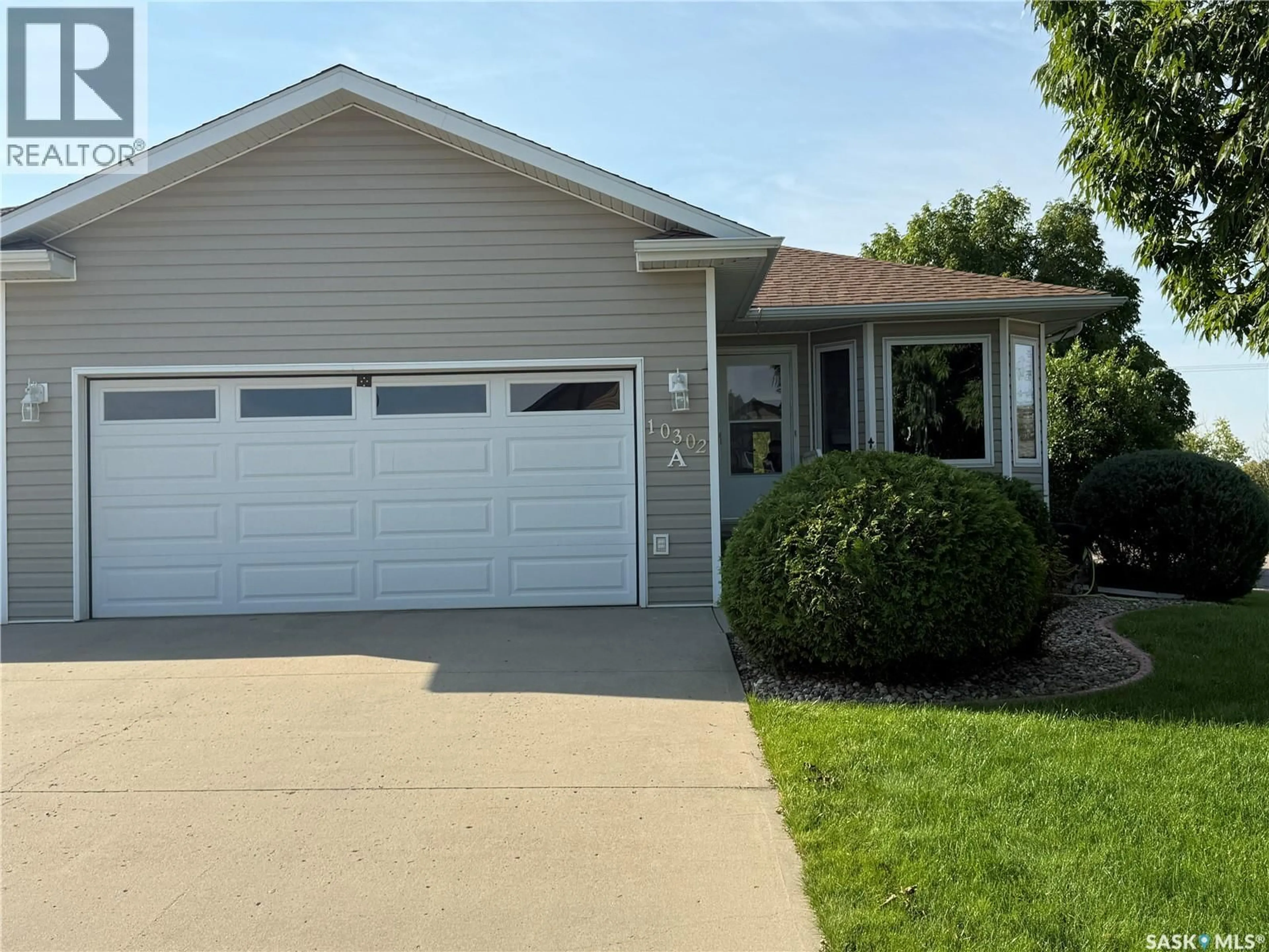 Home with vinyl exterior material, street for 10302 HENDERSON DRIVE, North Battleford Saskatchewan S9A3Y3