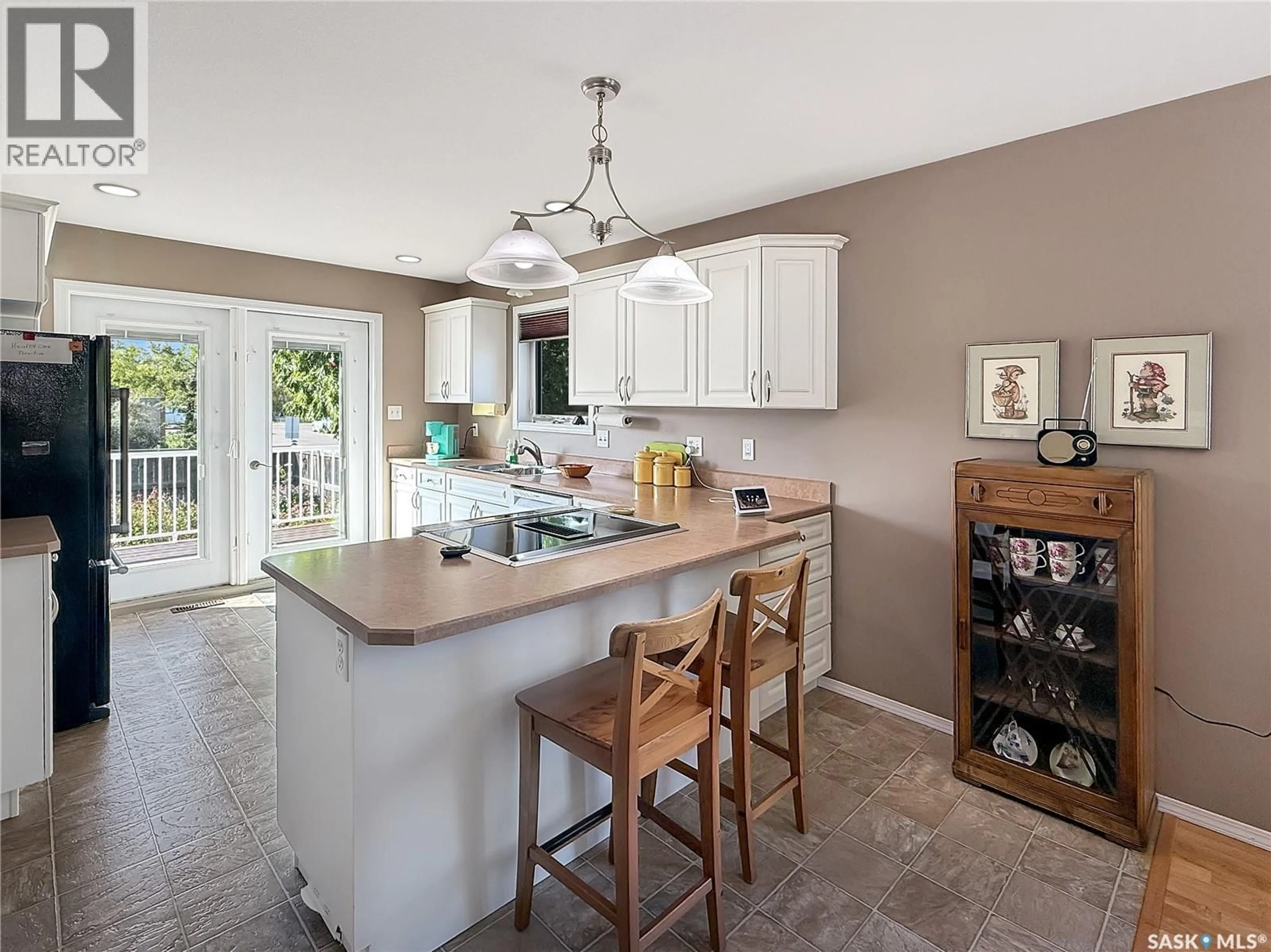Open concept kitchen, ceramic/tile floor for 10302 HENDERSON DRIVE, North Battleford Saskatchewan S9A3Y3