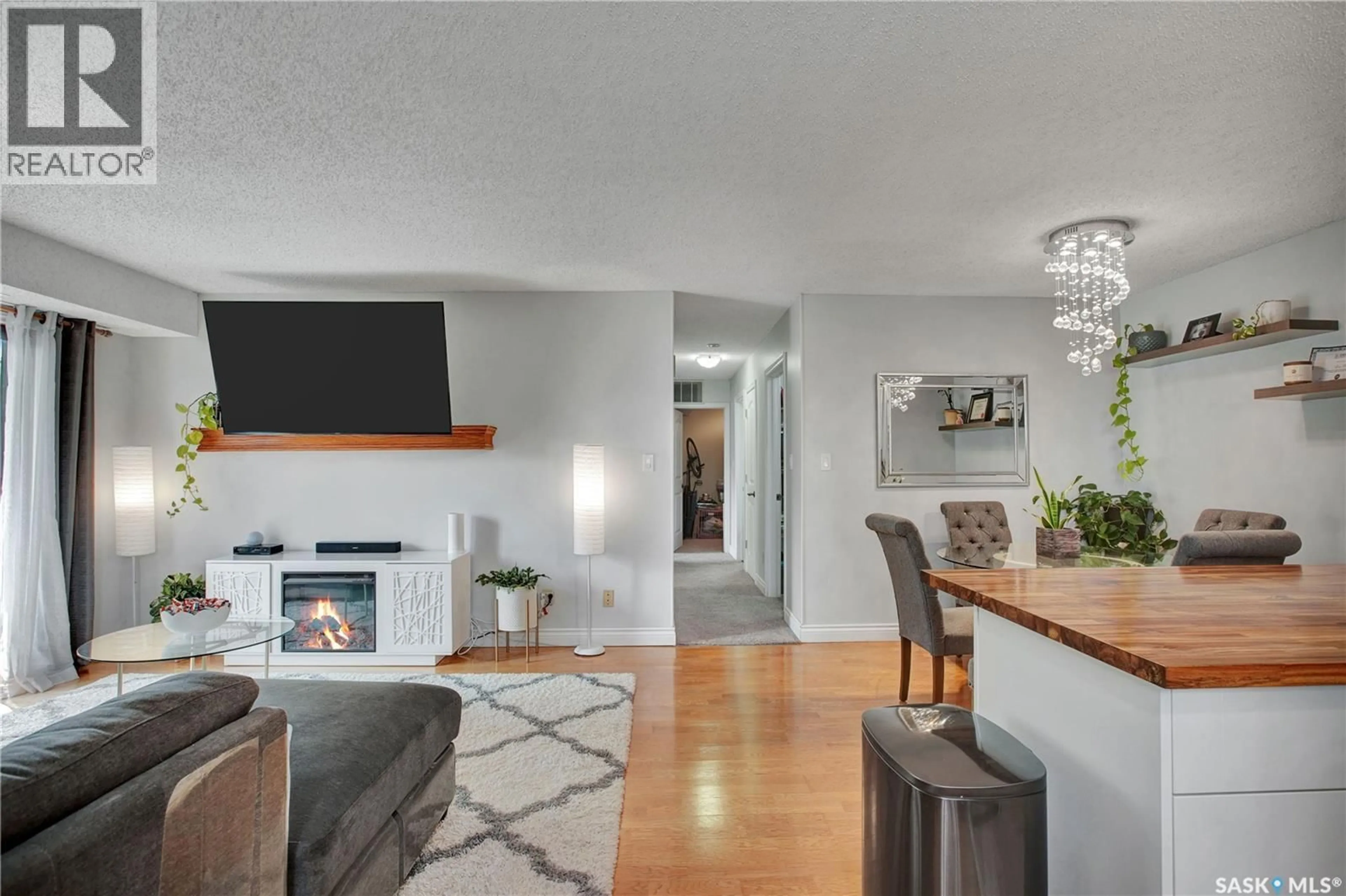 Living room with furniture, wood/laminate floor for 202D - 213 MAIN STREET, Martensville Saskatchewan S0K2T0