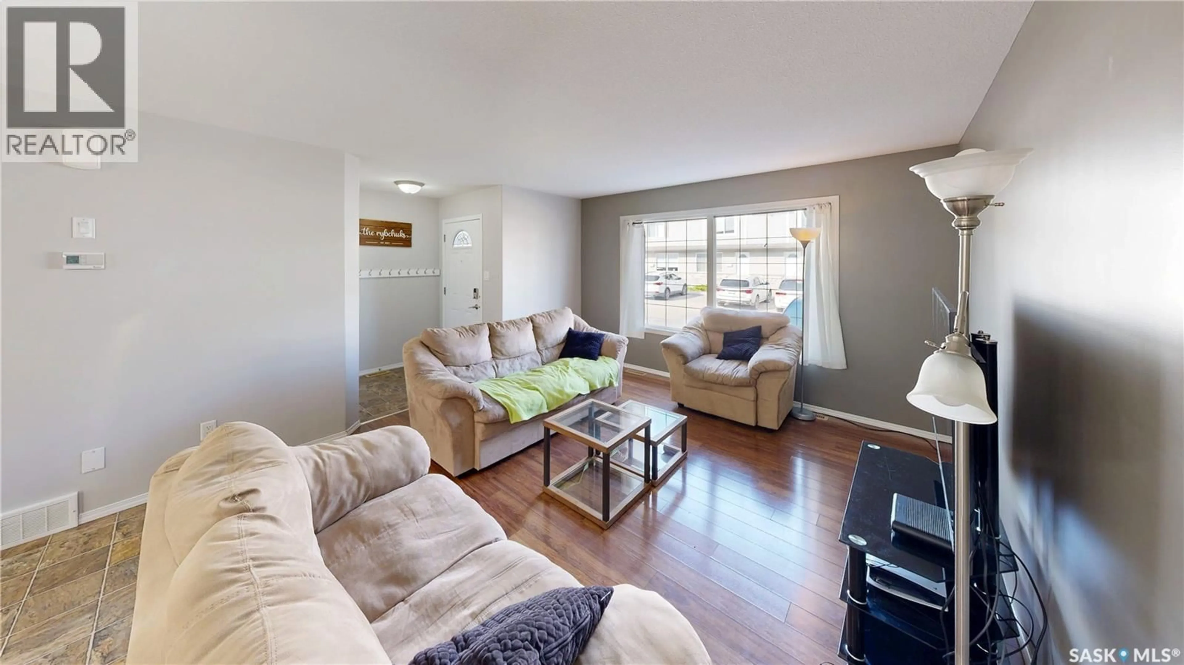 Living room with furniture, wood/laminate floor for 4801 - 156 CHILD AVENUE, Regina Saskatchewan S4X0C4