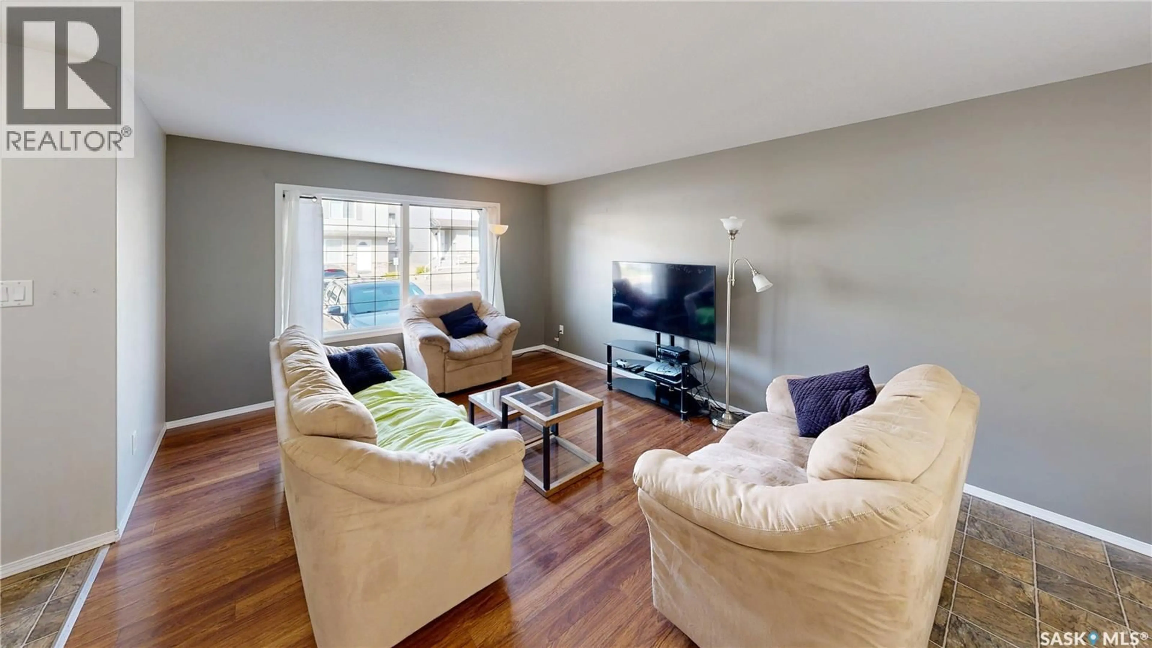 Living room with furniture, wood/laminate floor for 4801 - 156 CHILD AVENUE, Regina Saskatchewan S4X0C4