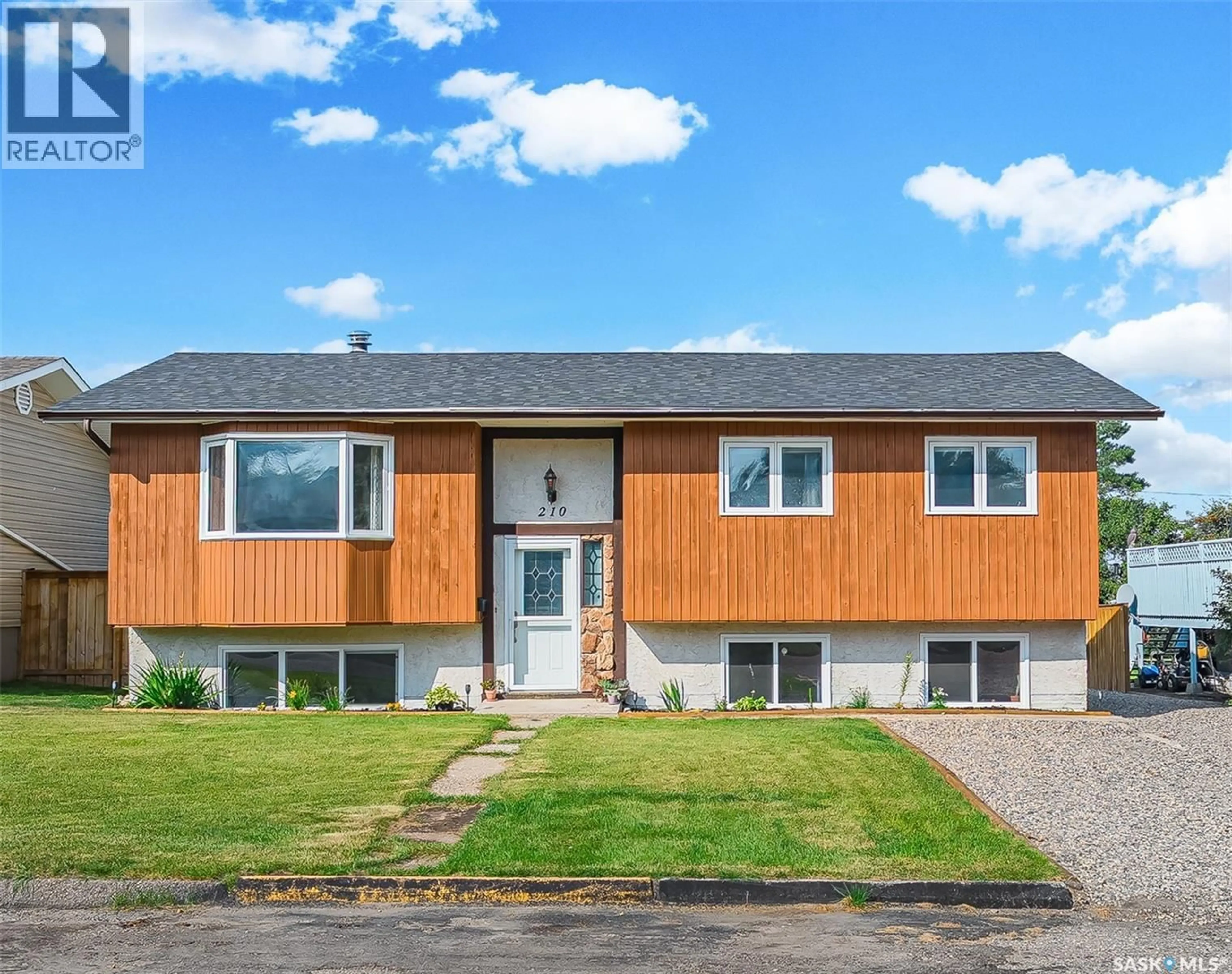 Home with vinyl exterior material, street for 210 4TH STREET, Delisle Saskatchewan S0L0P0
