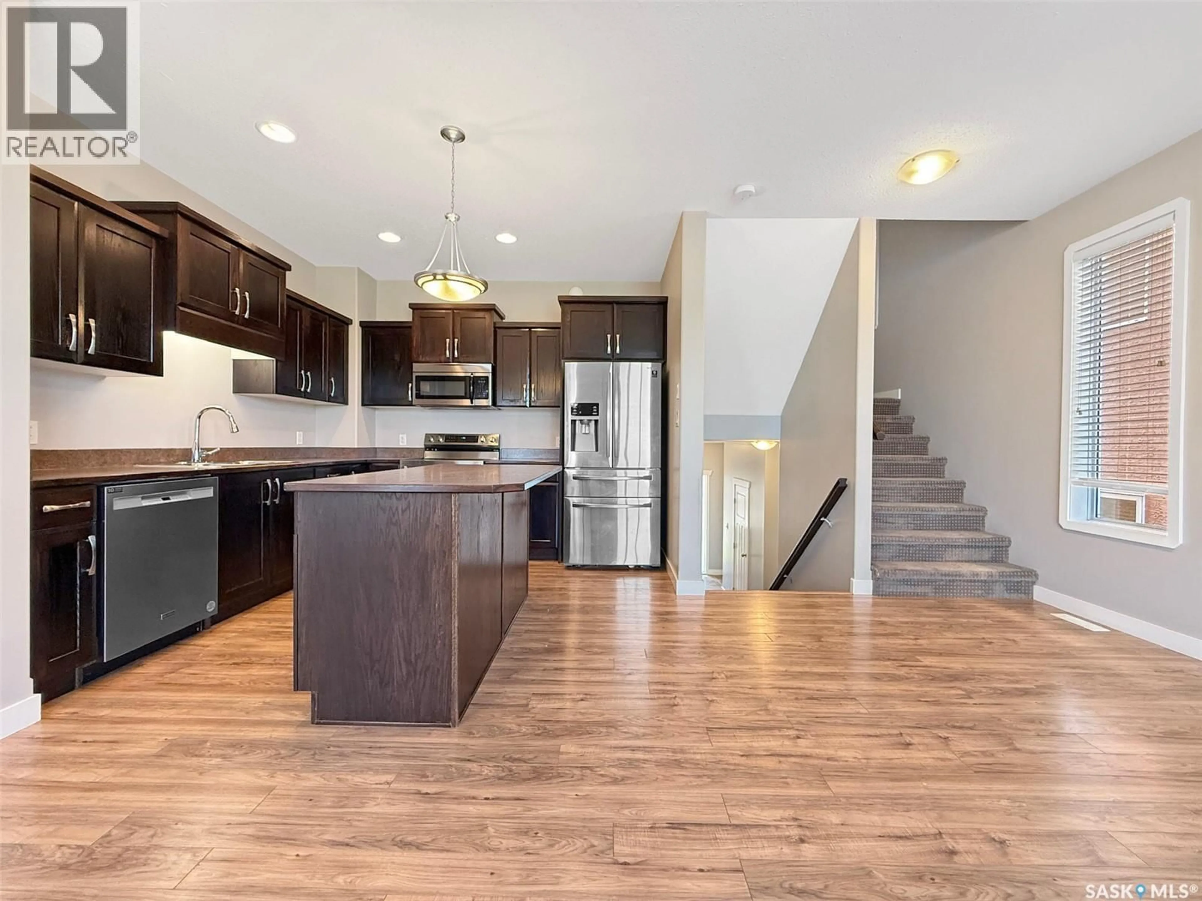Open concept kitchen, wood/laminate floor for 8 701 MCINTOSH STREET E, Swift Current Saskatchewan S9H1H7