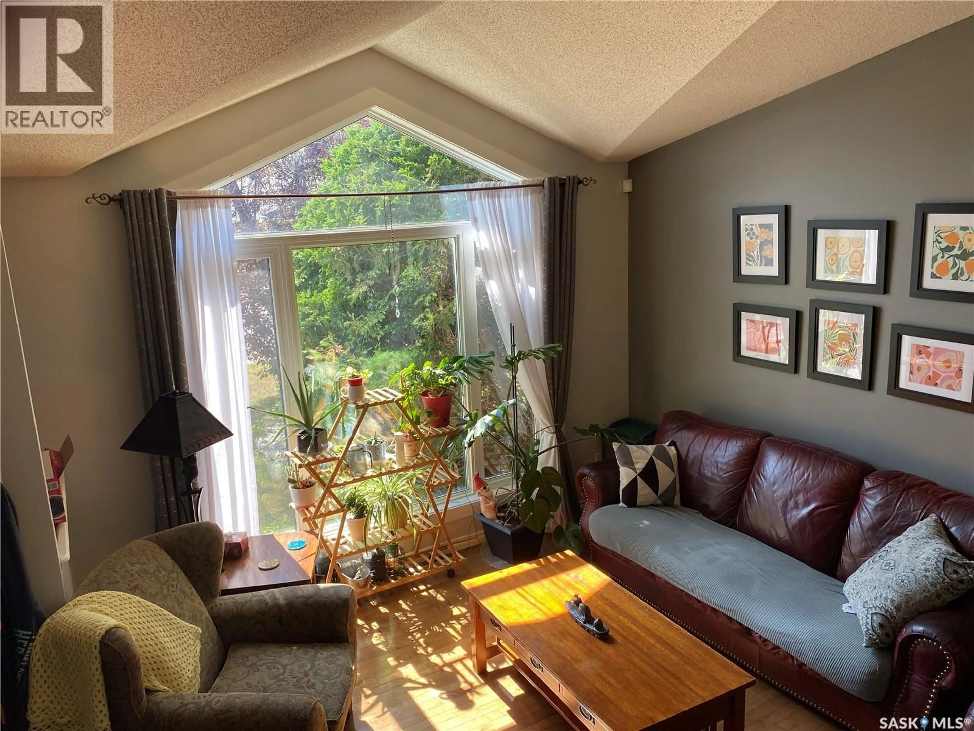 Living room with furniture, wood/laminate floor for 1810 WAGMAN DRIVE, Regina Saskatchewan S4V2R7