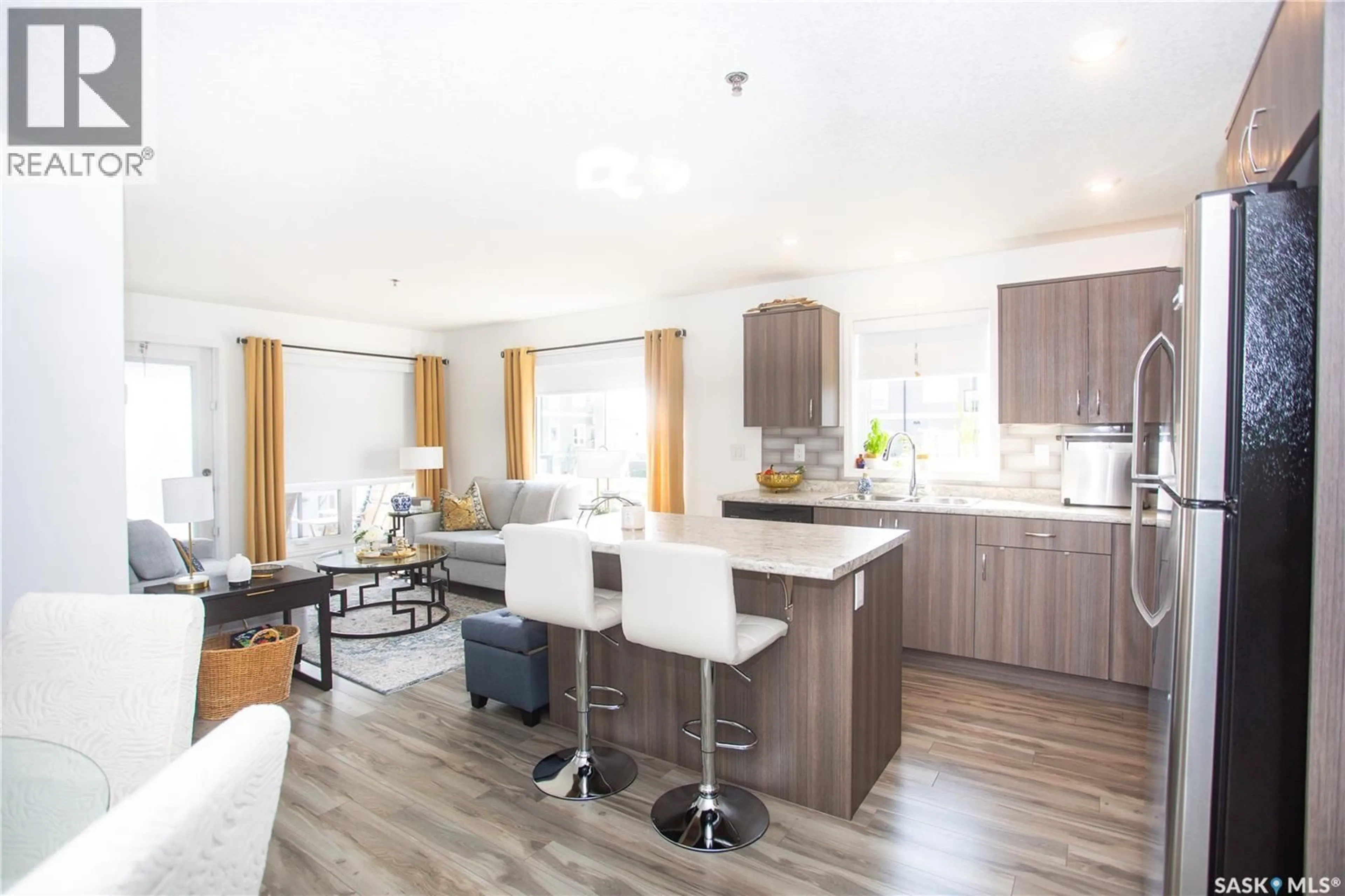 Open concept kitchen, wood/laminate floor for 108 - 4205 WILLIS CRESCENT, Saskatoon Saskatchewan S7T0W8