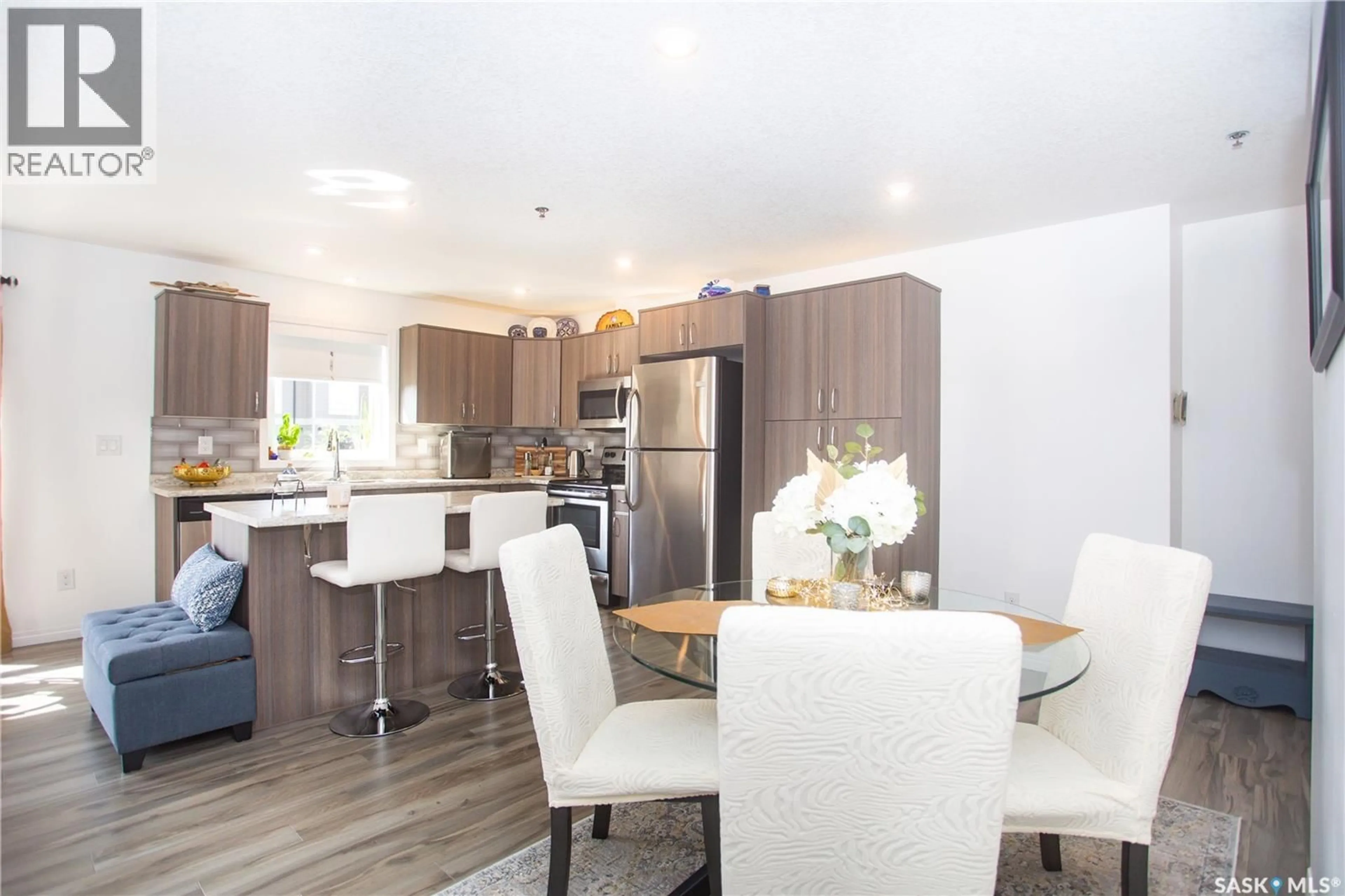 Open concept kitchen, wood/laminate floor for 108 - 4205 WILLIS CRESCENT, Saskatoon Saskatchewan S7T0W8