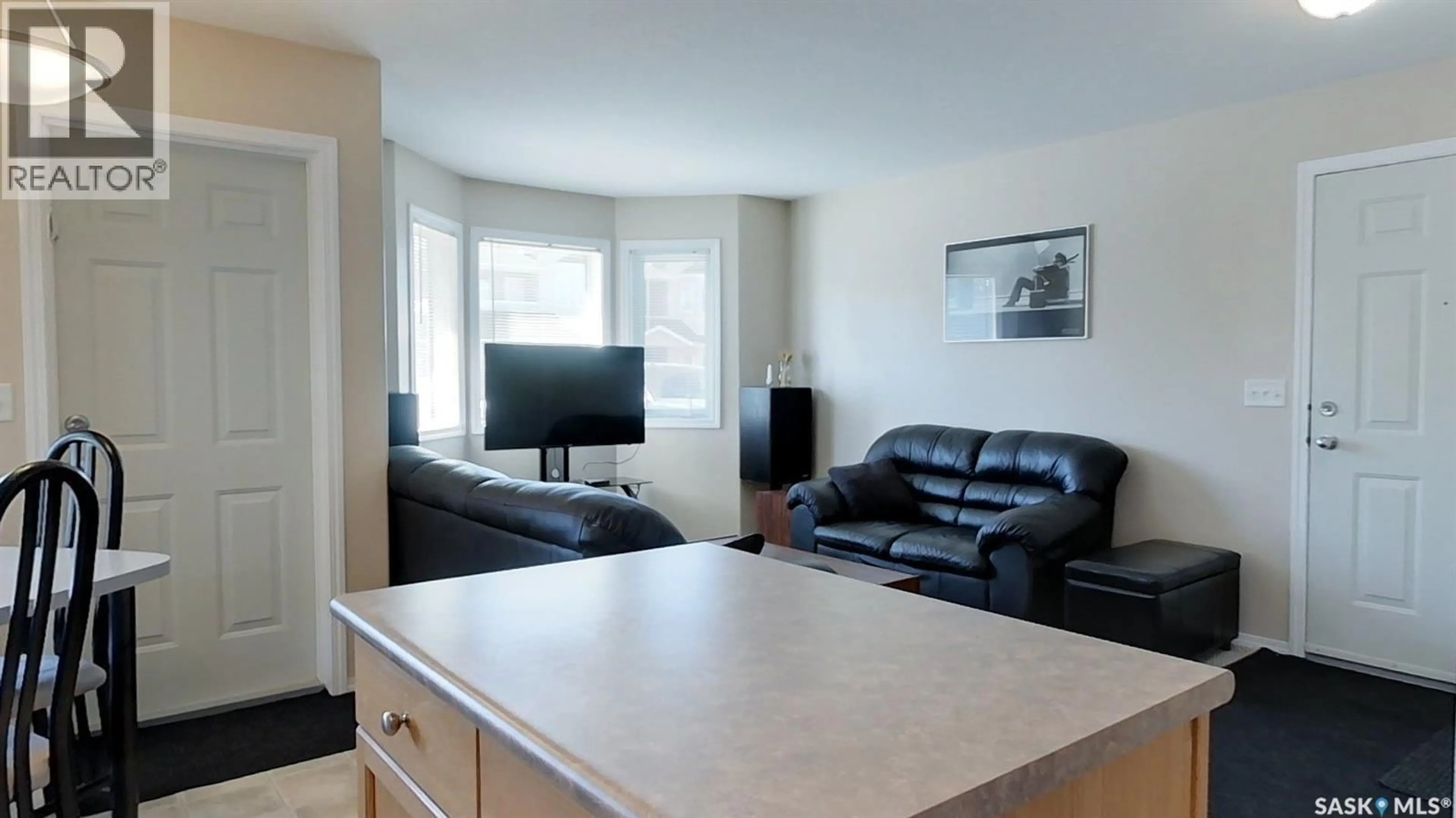 Living room with furniture, wood/laminate floor for E - 4146 BUCKINGHAM DRIVE, Regina Saskatchewan S4V3A9