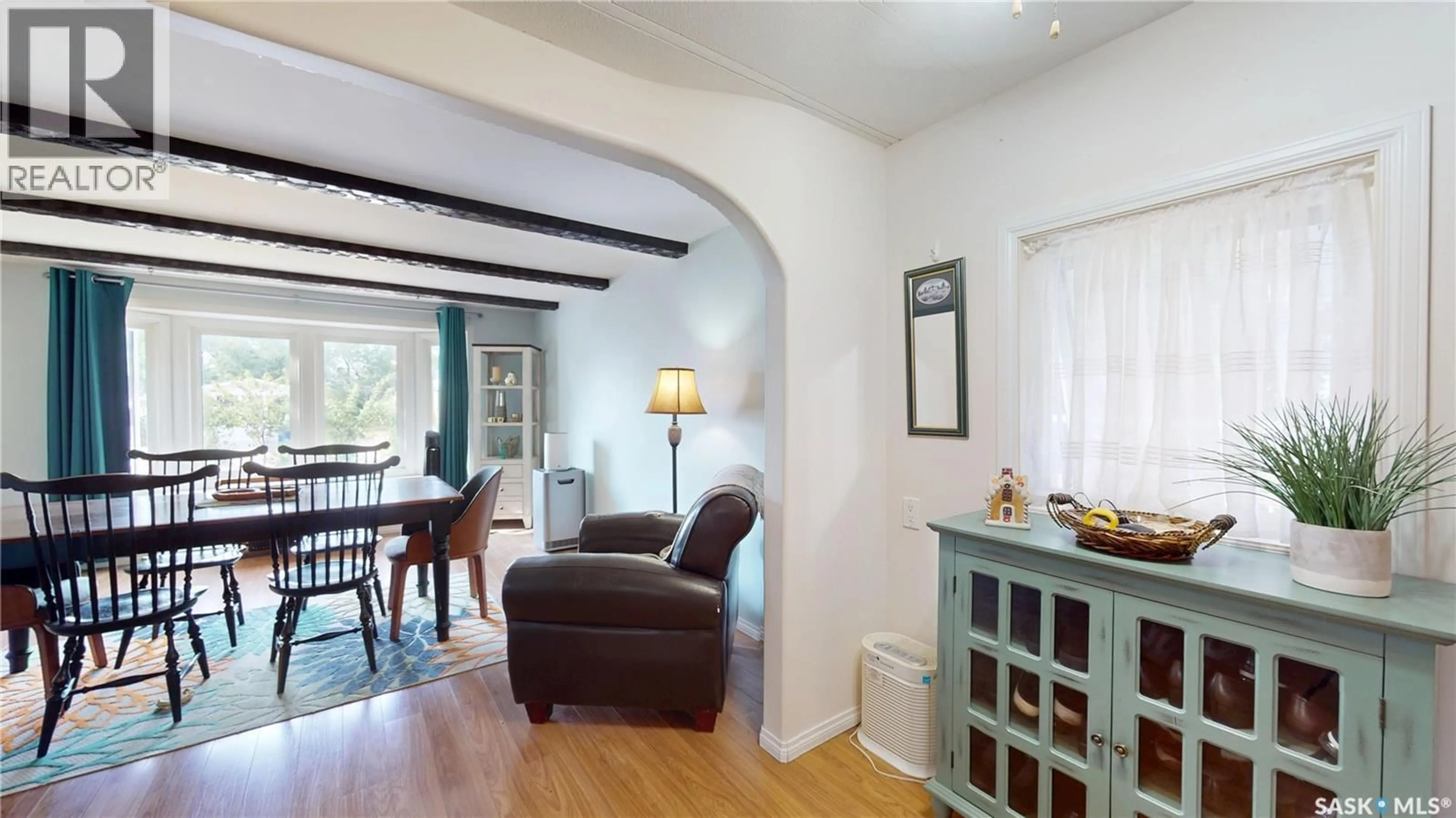 Living room with furniture, wood/laminate floor for A24 - 1295 9TH AVENUE, Moose Jaw Saskatchewan S6J1C5