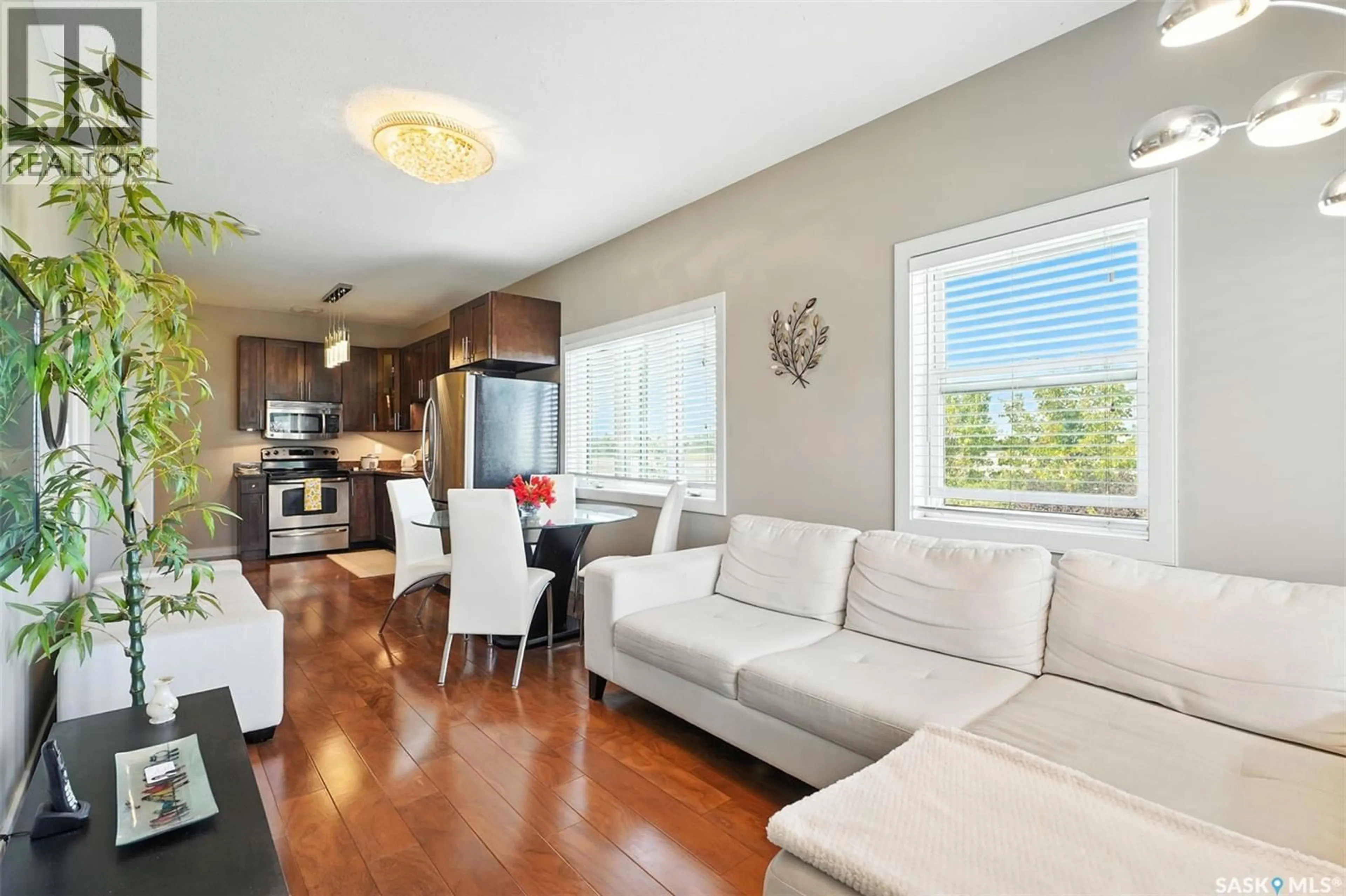 Living room with furniture, wood/laminate floor for 47 - 1703 PATRICK CRESCENT, Saskatoon Saskatchewan S7W0L6