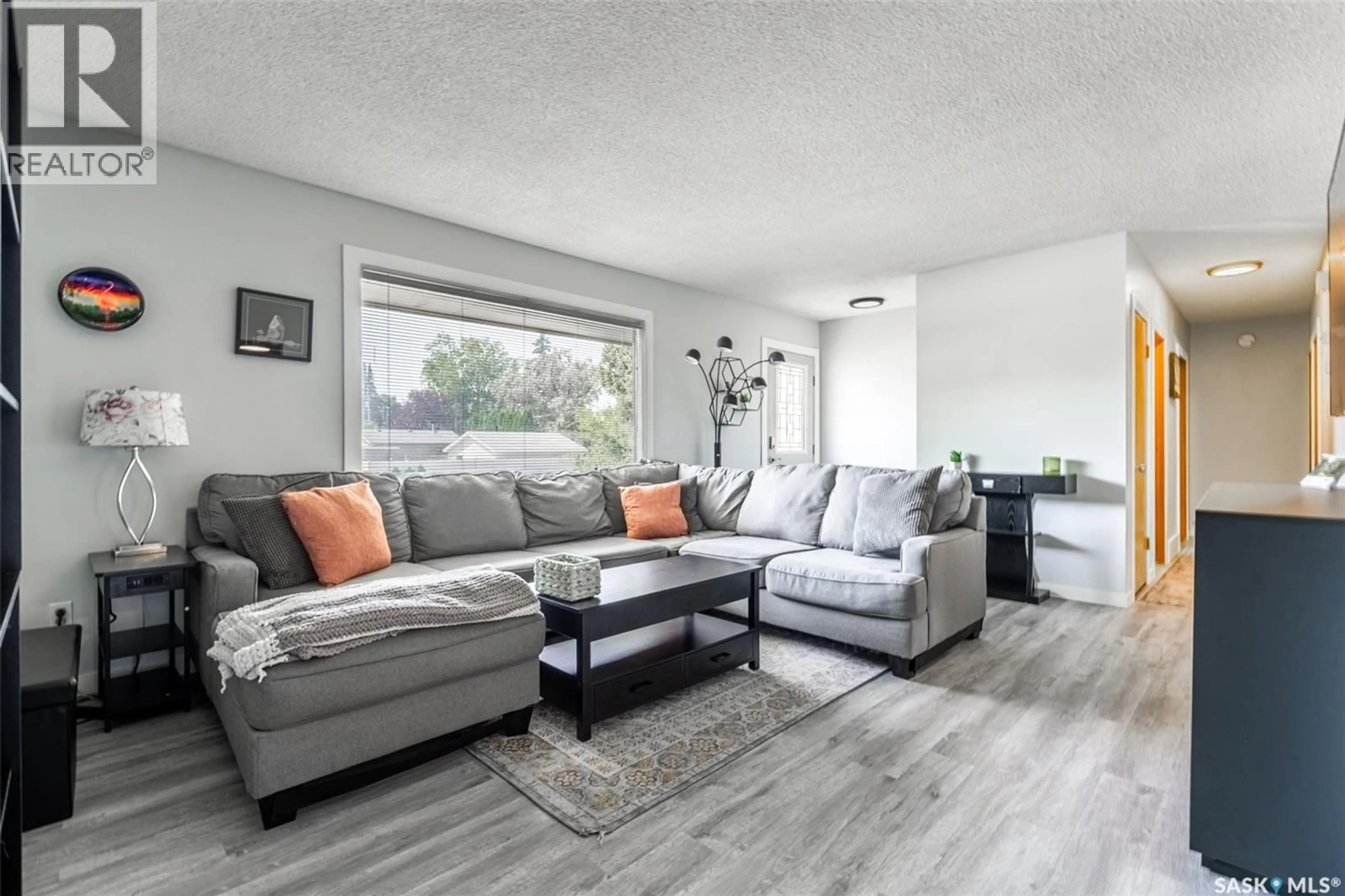 Living room with furniture, wood/laminate floor for 1125 WILSON CRESCENT, Saskatoon Saskatchewan S7J2M7