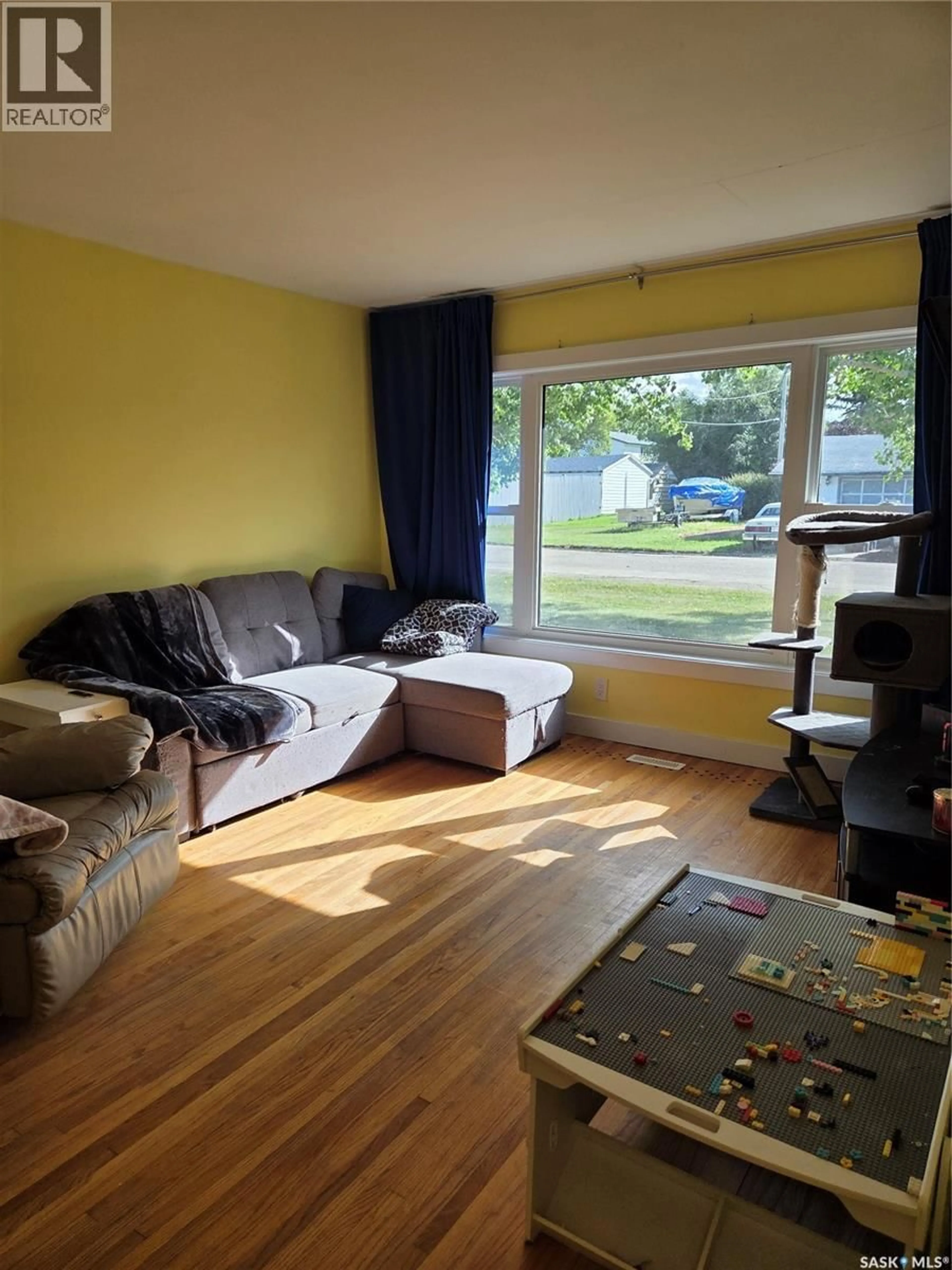 Living room with furniture, wood/laminate floor for 1101 KNOX AVENUE, Rouleau Saskatchewan S0G4H0