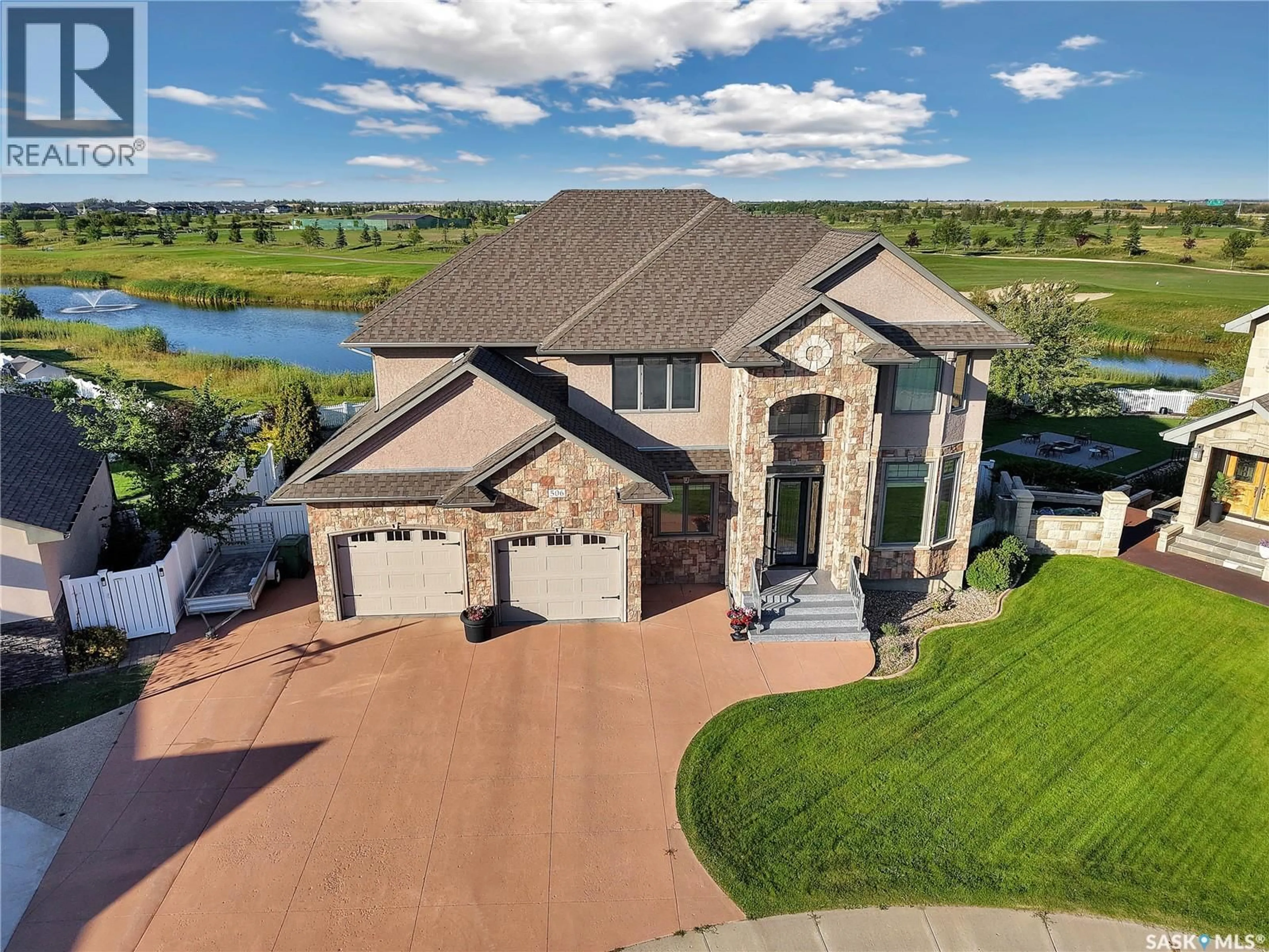 A pic from outside/outdoor area/front of a property/back of a property/a pic from drone, water/lake/river/ocean view for 506 HOGAN GREEN, Warman Saskatchewan S0K4S1