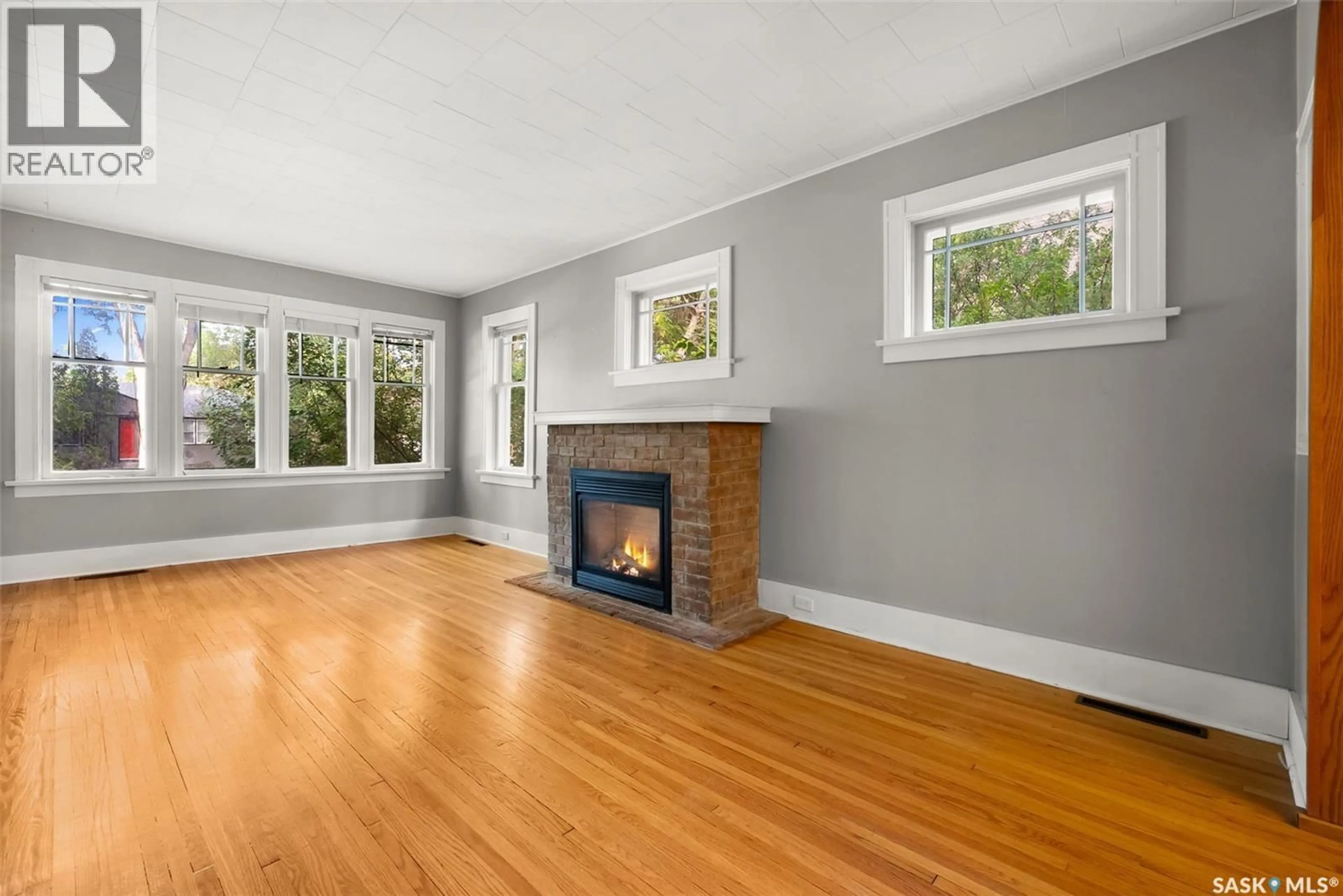Living room with furniture, wood/laminate floor for 3057 RETALLACK STREET, Regina Saskatchewan S4S1T3