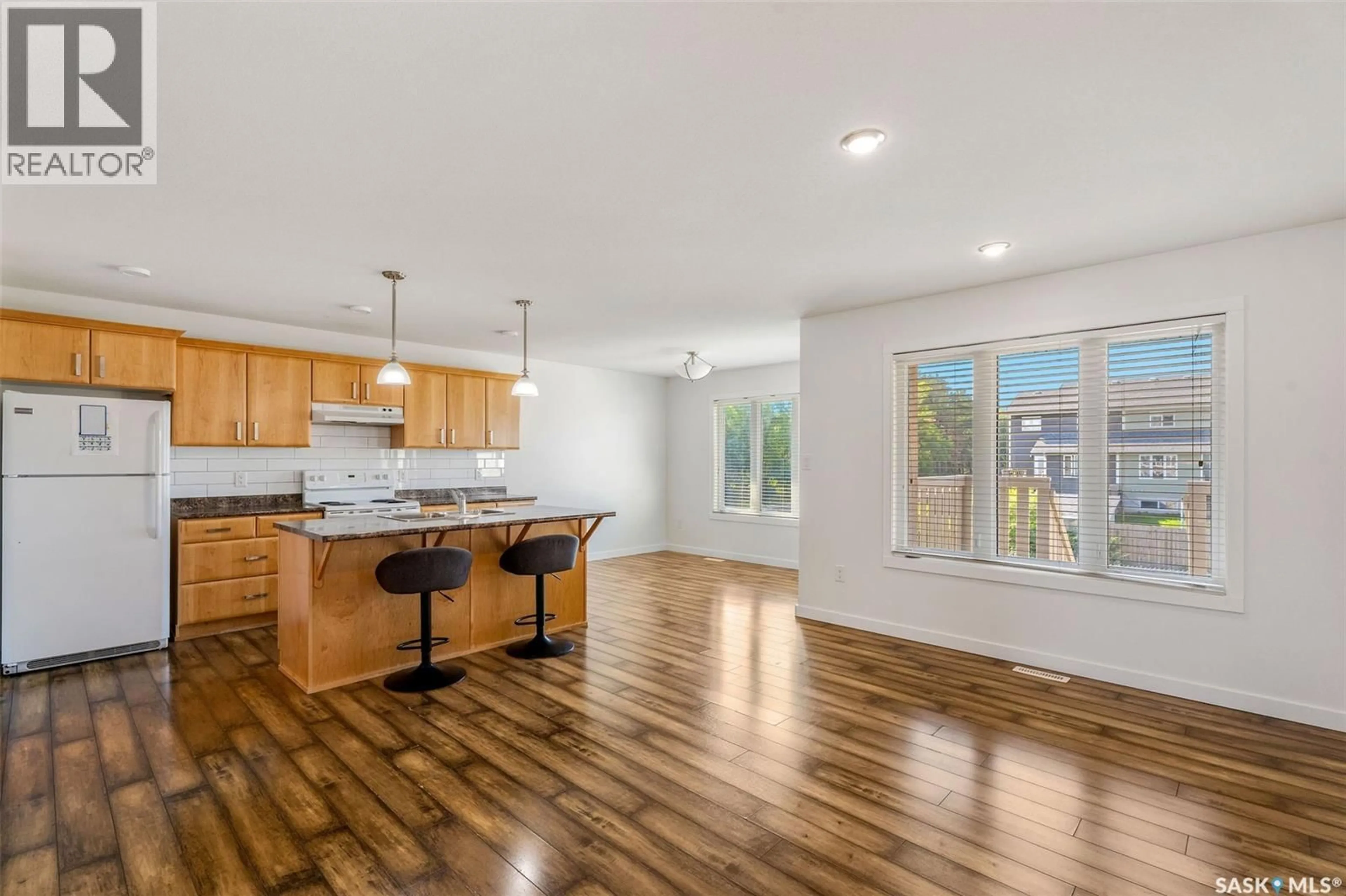 Open concept kitchen, wood/laminate floor for 893 5TH STREET, Prince Albert Saskatchewan S6V2L6