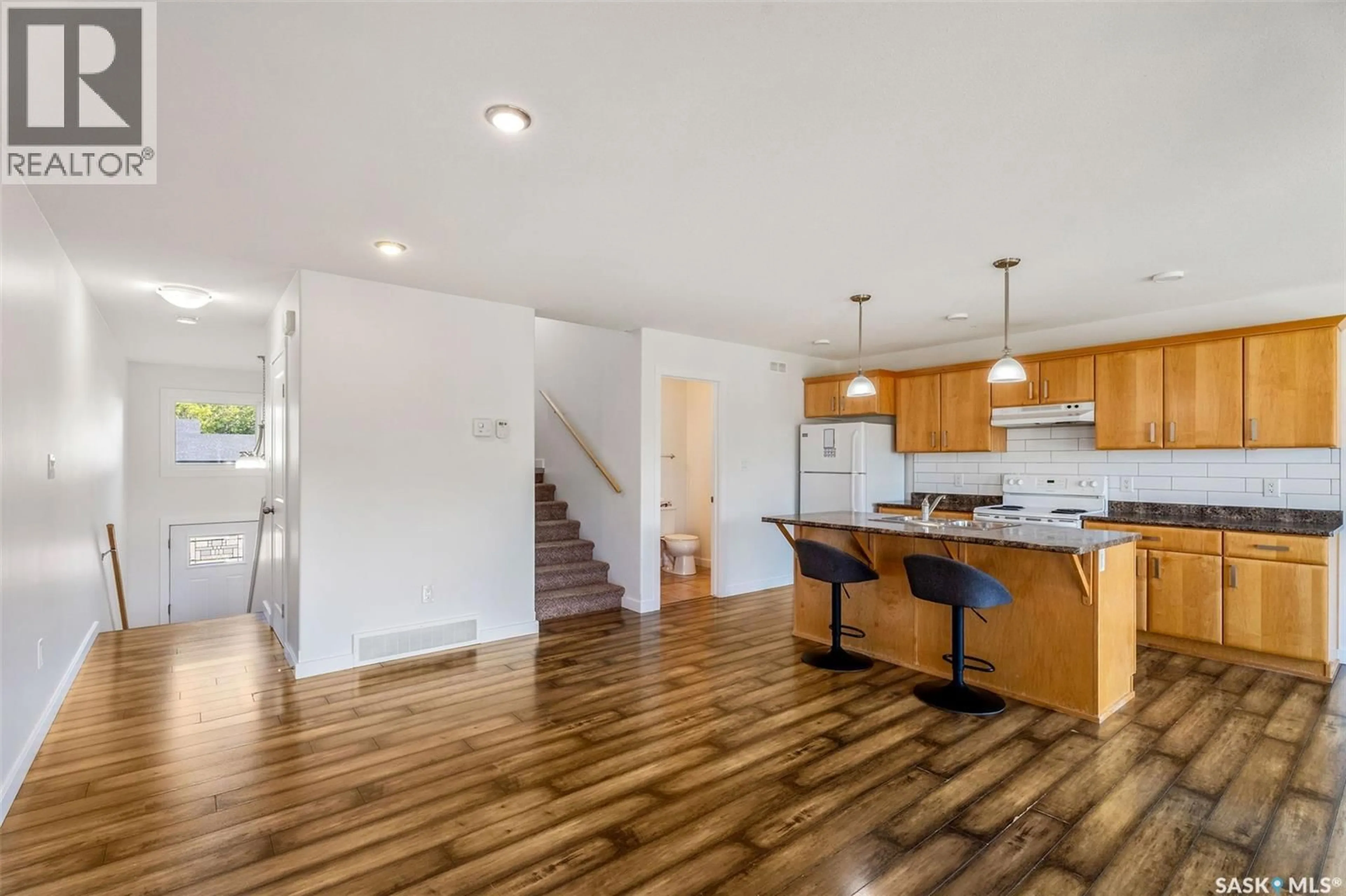 Open concept kitchen, wood/laminate floor for 893 5TH STREET, Prince Albert Saskatchewan S6V2L6