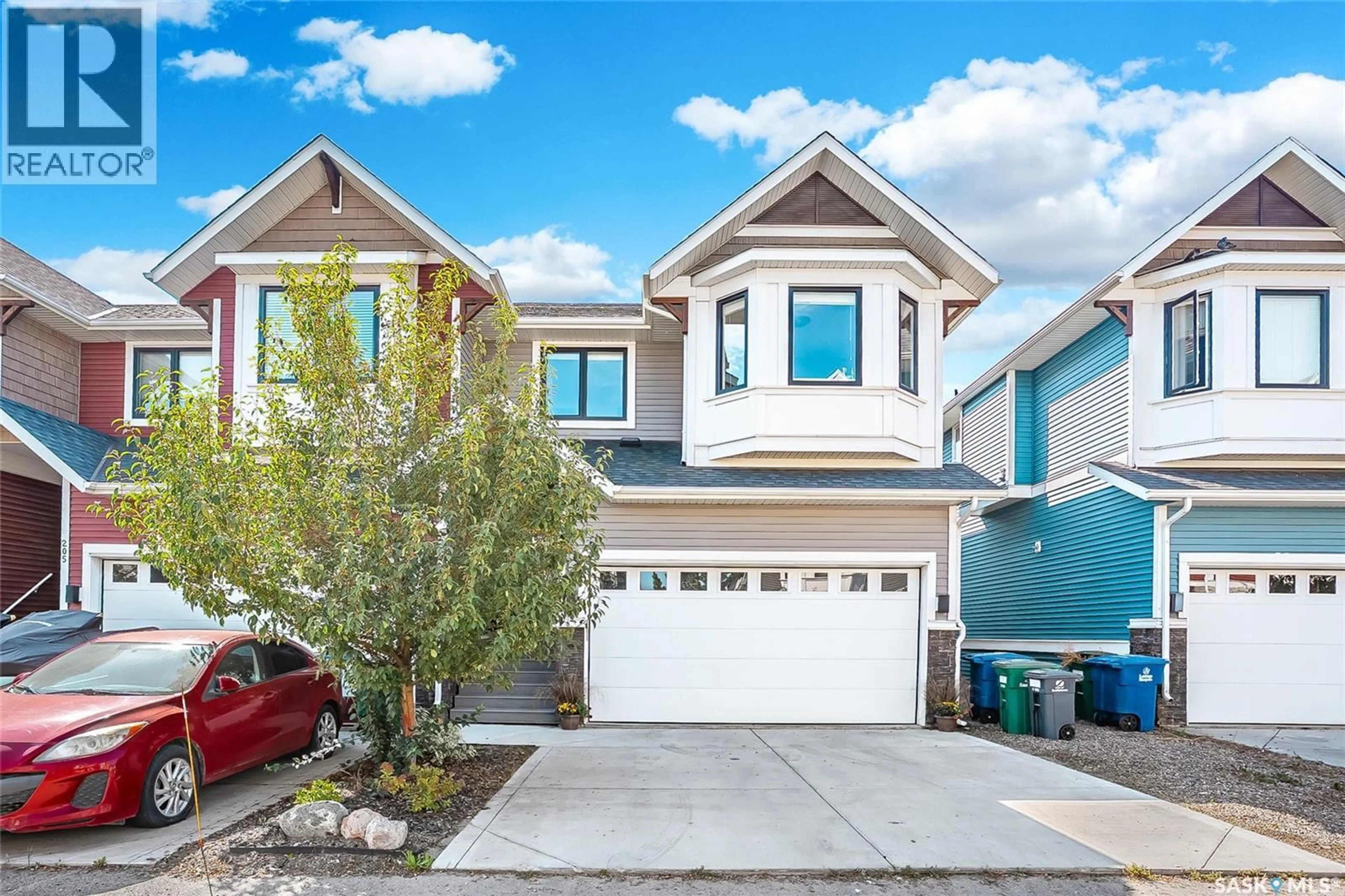 Home with vinyl exterior material, street for 207 - 3220 11TH STREET, Saskatoon Saskatchewan S7M5M4
