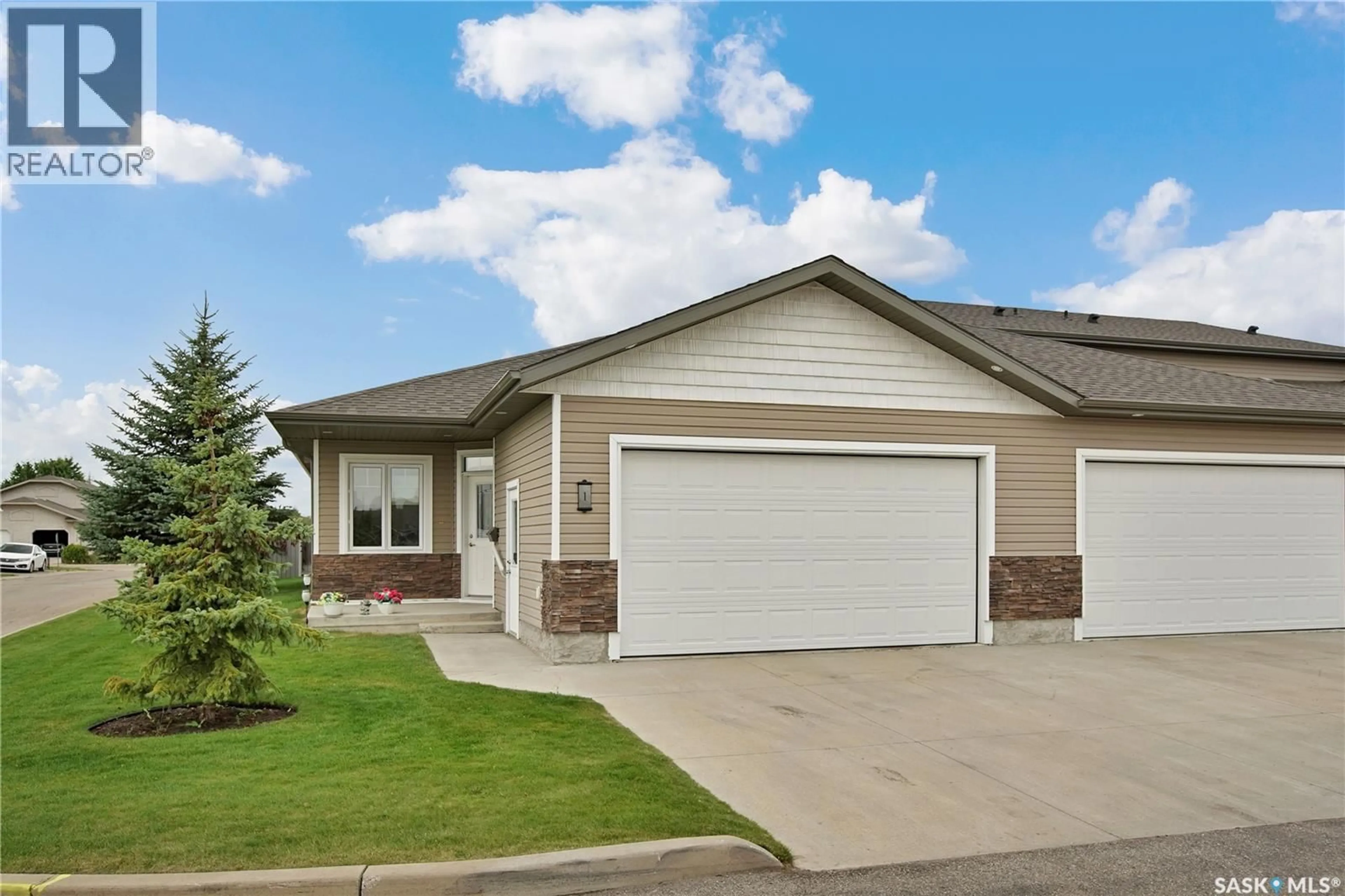 Home with vinyl exterior material, street for 1 100 BROOKLYN LANE, Warman Saskatchewan S0K0A1