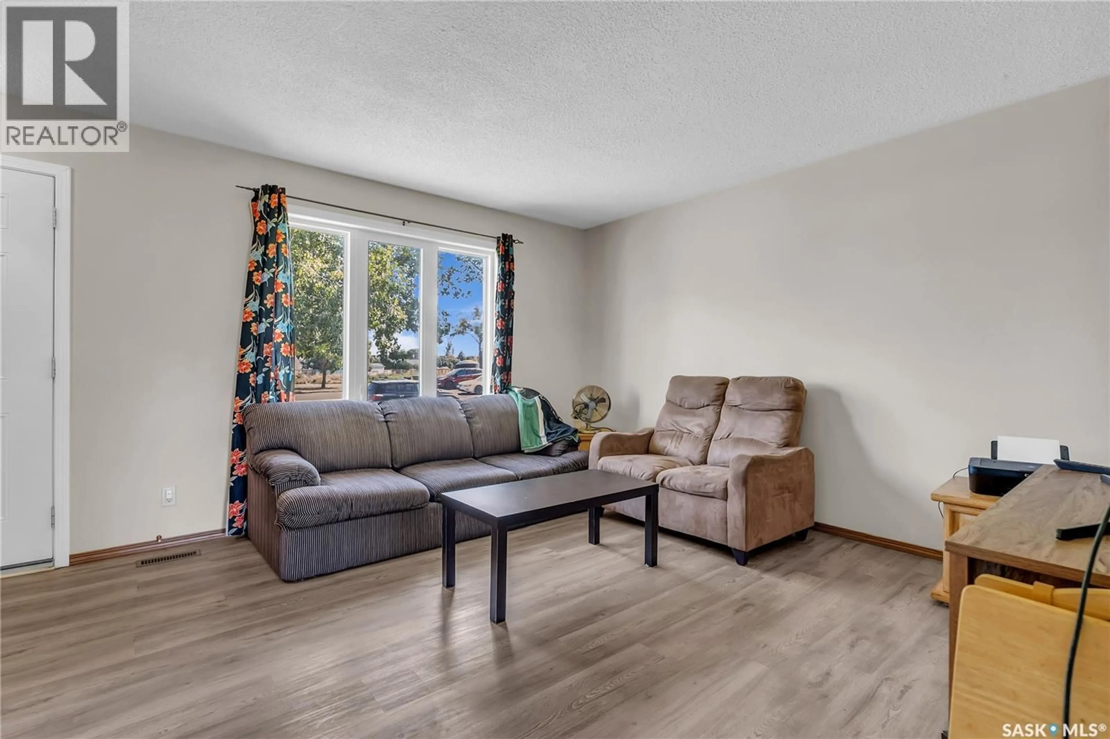 Living room with furniture, wood/laminate floor for 458 & 460 BERINI DRIVE, Saskatoon Saskatchewan S7N3N6