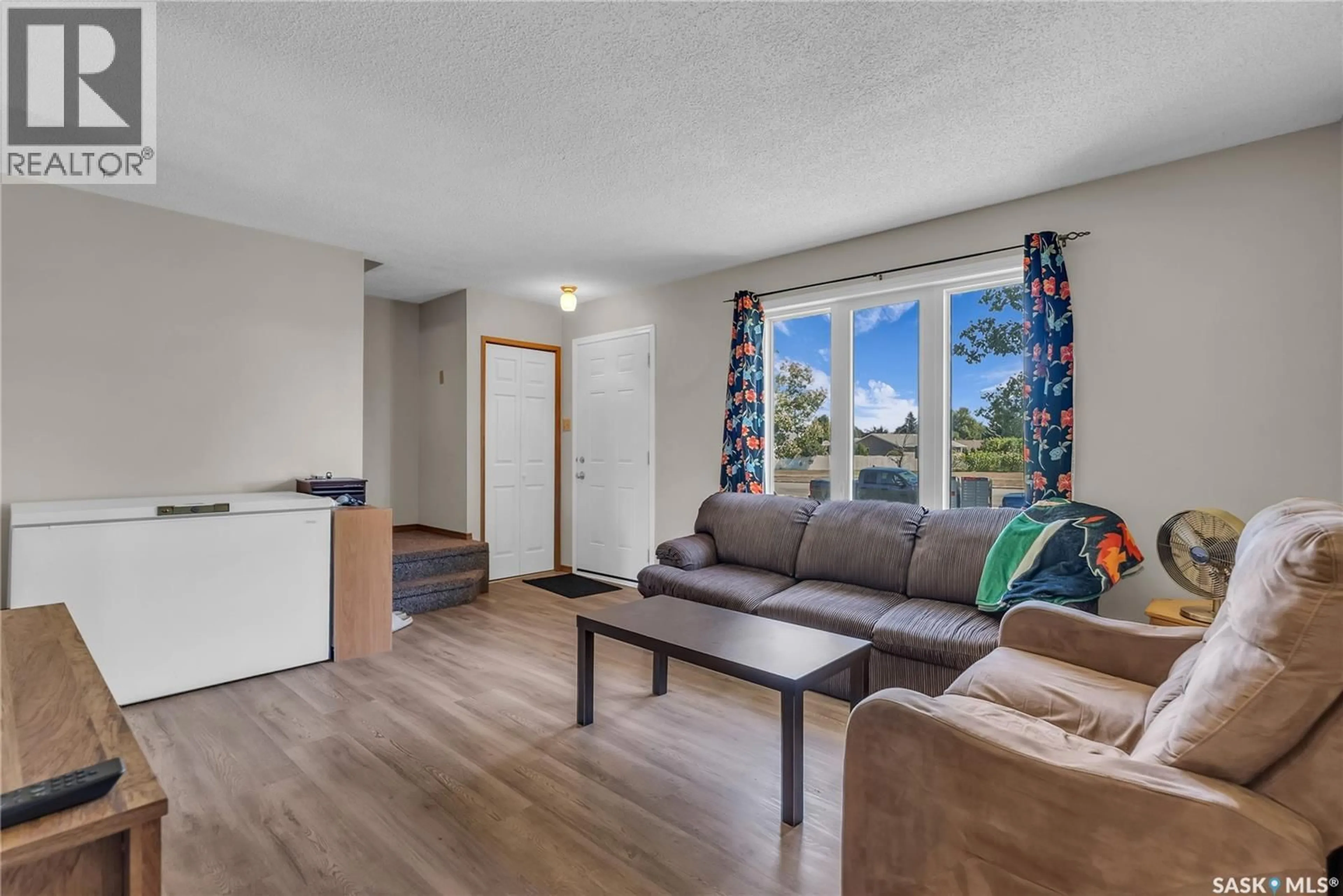 Living room with furniture, wood/laminate floor for 458 & 460 BERINI DRIVE, Saskatoon Saskatchewan S7N3N6
