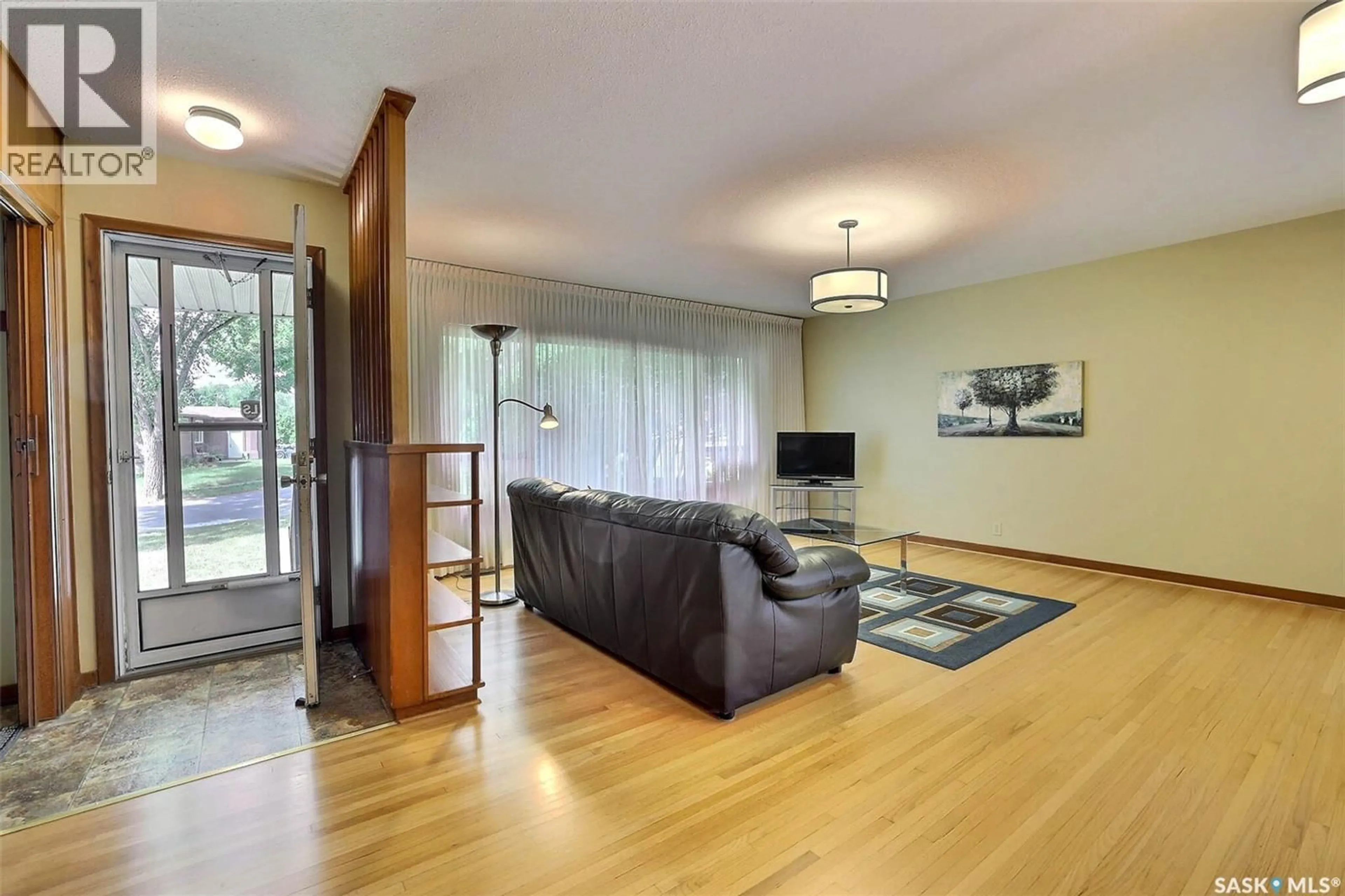 Living room with furniture, wood/laminate floor for 37 DARKE CRESCENT, Regina Saskatchewan S4S2W5
