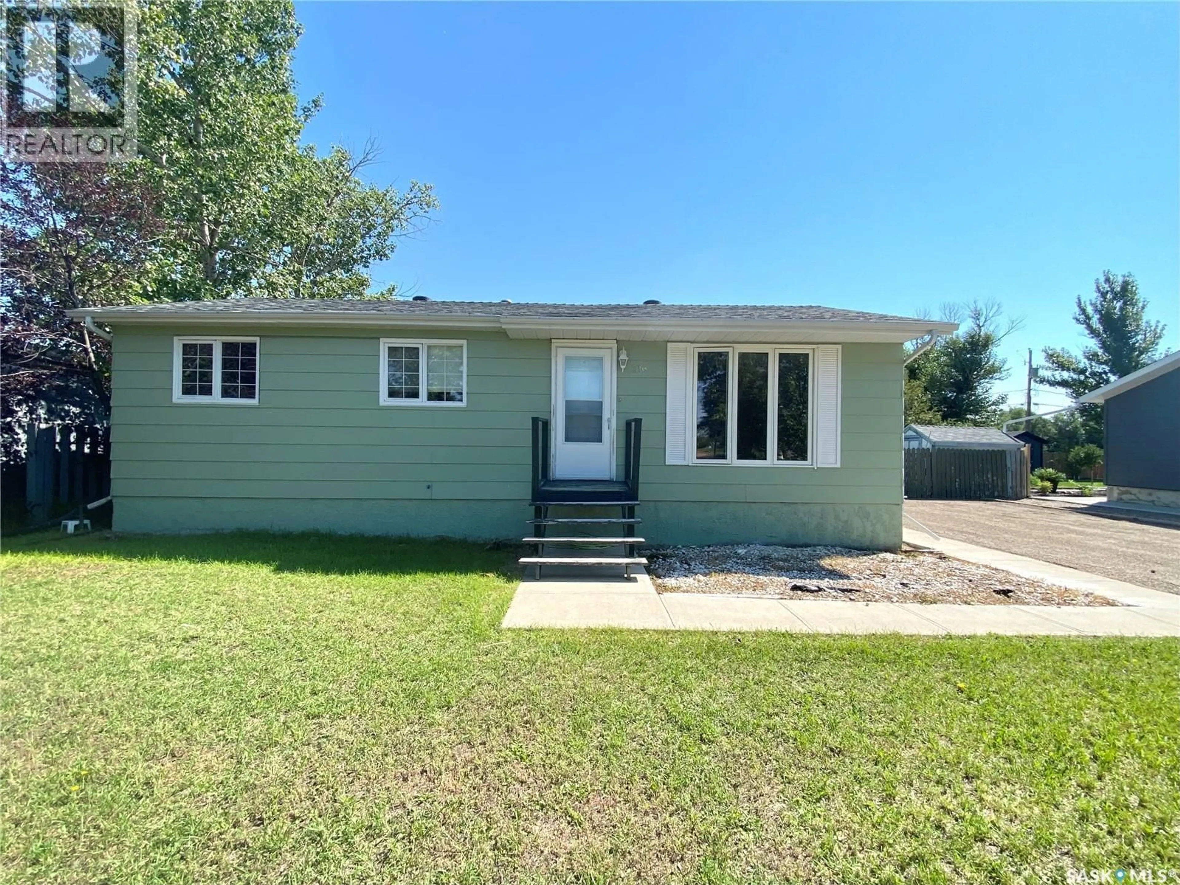 Home with vinyl exterior material, street for 216 3RD STREET, Frontier Saskatchewan S0N0W0