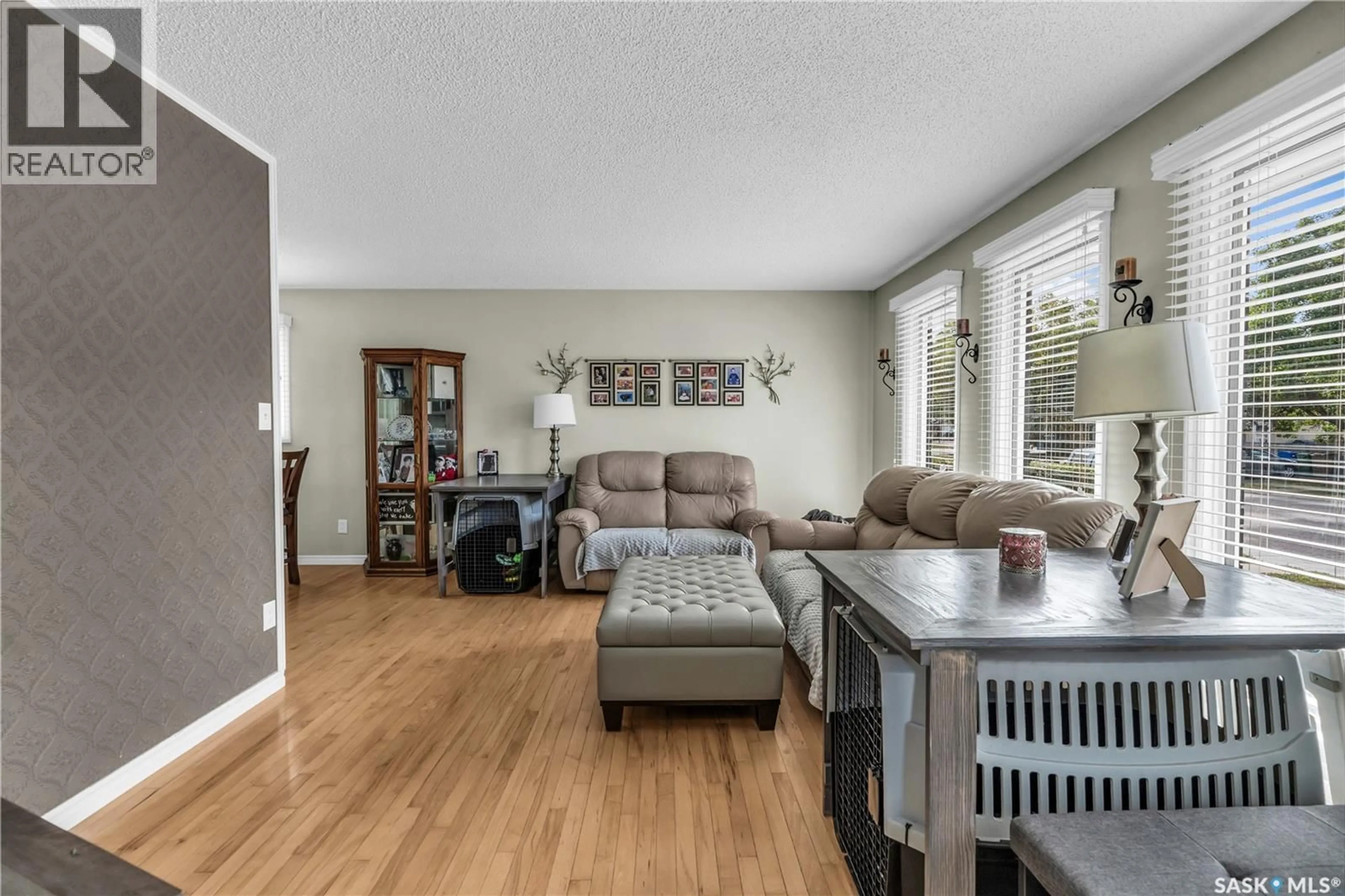 Living room with furniture, wood/laminate floor for 34 SCRIVENER CRESCENT, Regina Saskatchewan S4N4V7