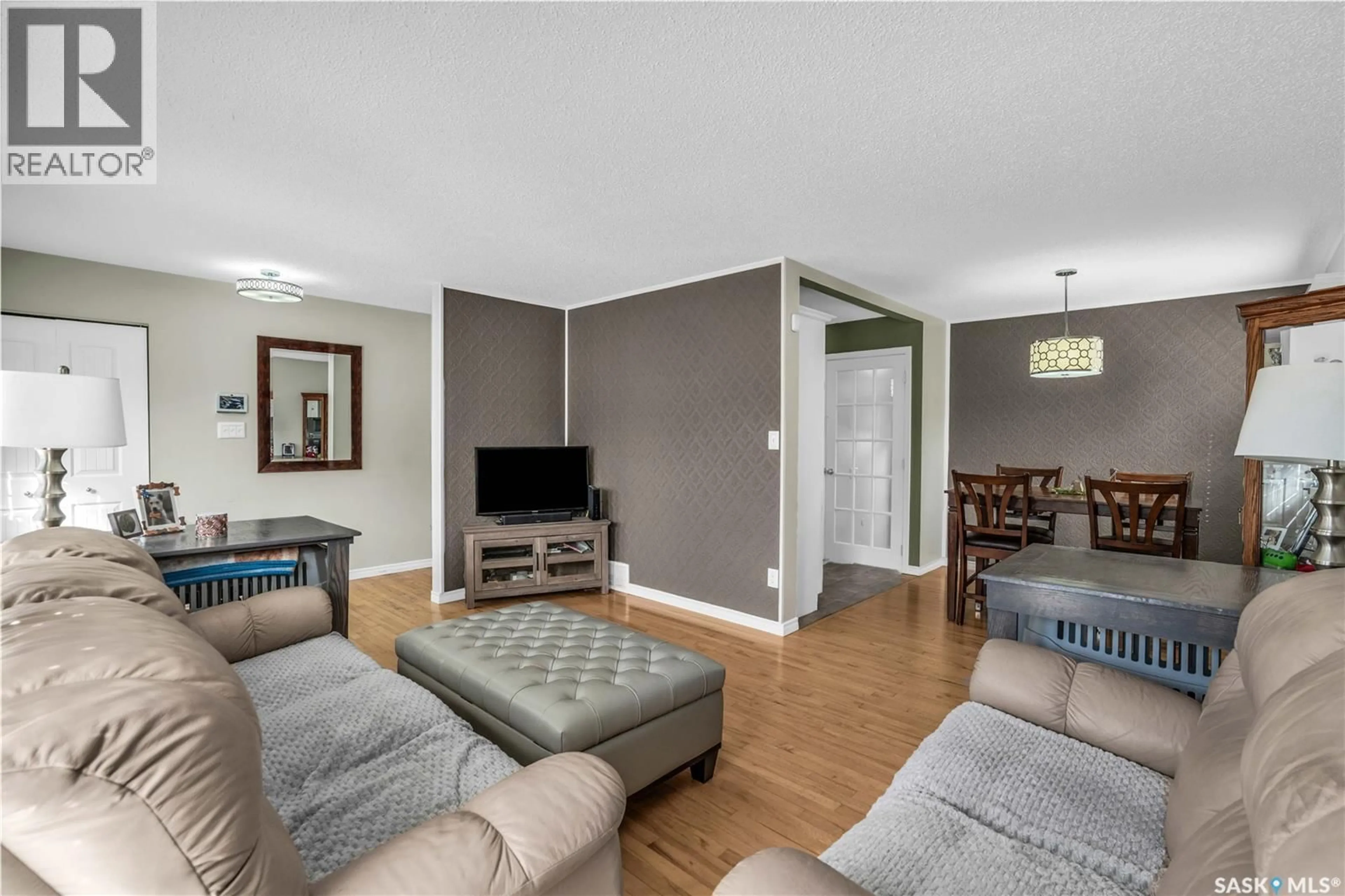 Living room with furniture, wood/laminate floor for 34 SCRIVENER CRESCENT, Regina Saskatchewan S4N4V7