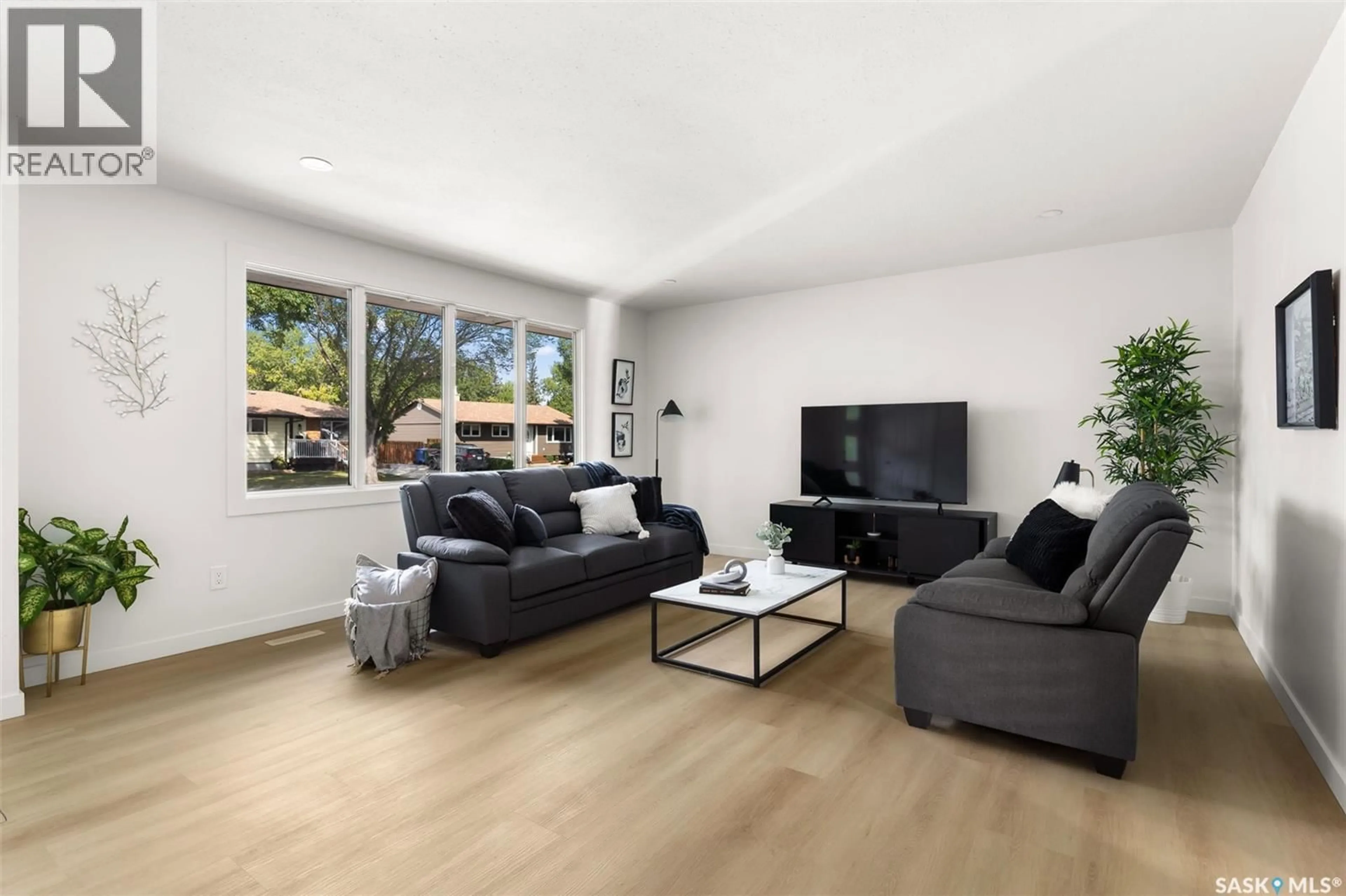 Living room with furniture, wood/laminate floor for 103 ELMVIEW ROAD, Regina Saskatchewan S4R0B5