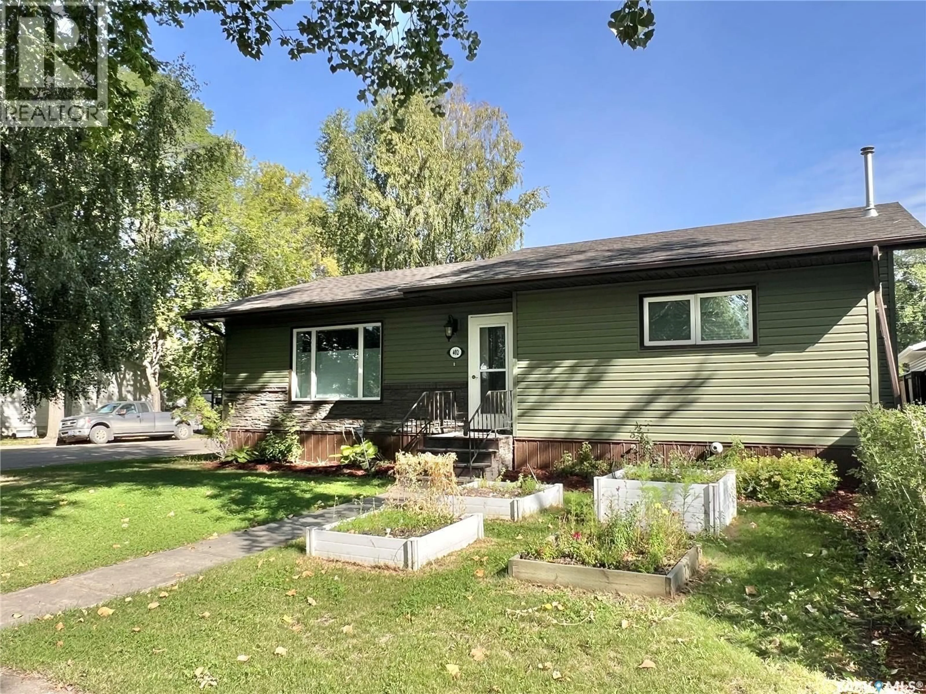 Home with vinyl exterior material, street for E - 402 CRAWFORD AVENUE, Melfort Saskatchewan S0E1A0